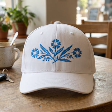 Classic CorningWare Pattern embroidered hat in White resting on a flat surface