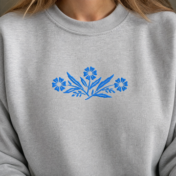 Model wearing the Cornflower Blue Flowers sweatshirt in Ash, lifestyle image 1