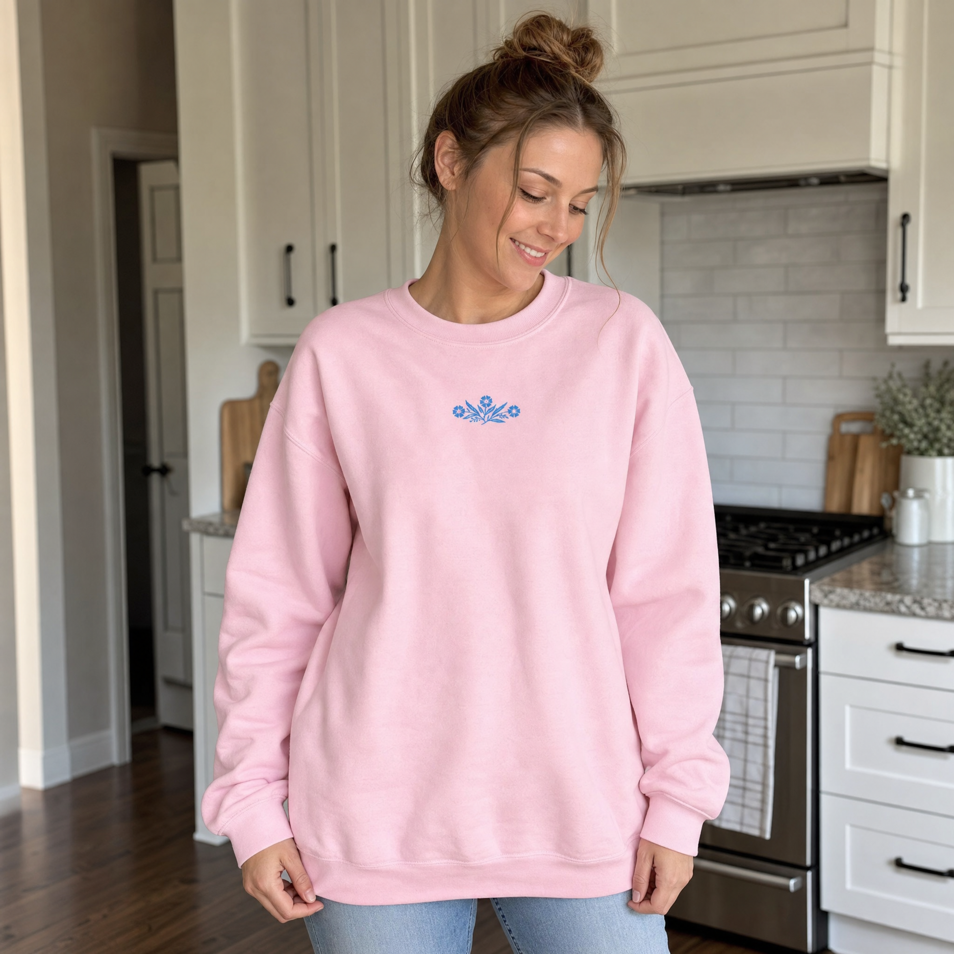Model wearing the Cornflower Blue Flowers sweatshirt in Light Pink, lifestyle image 1