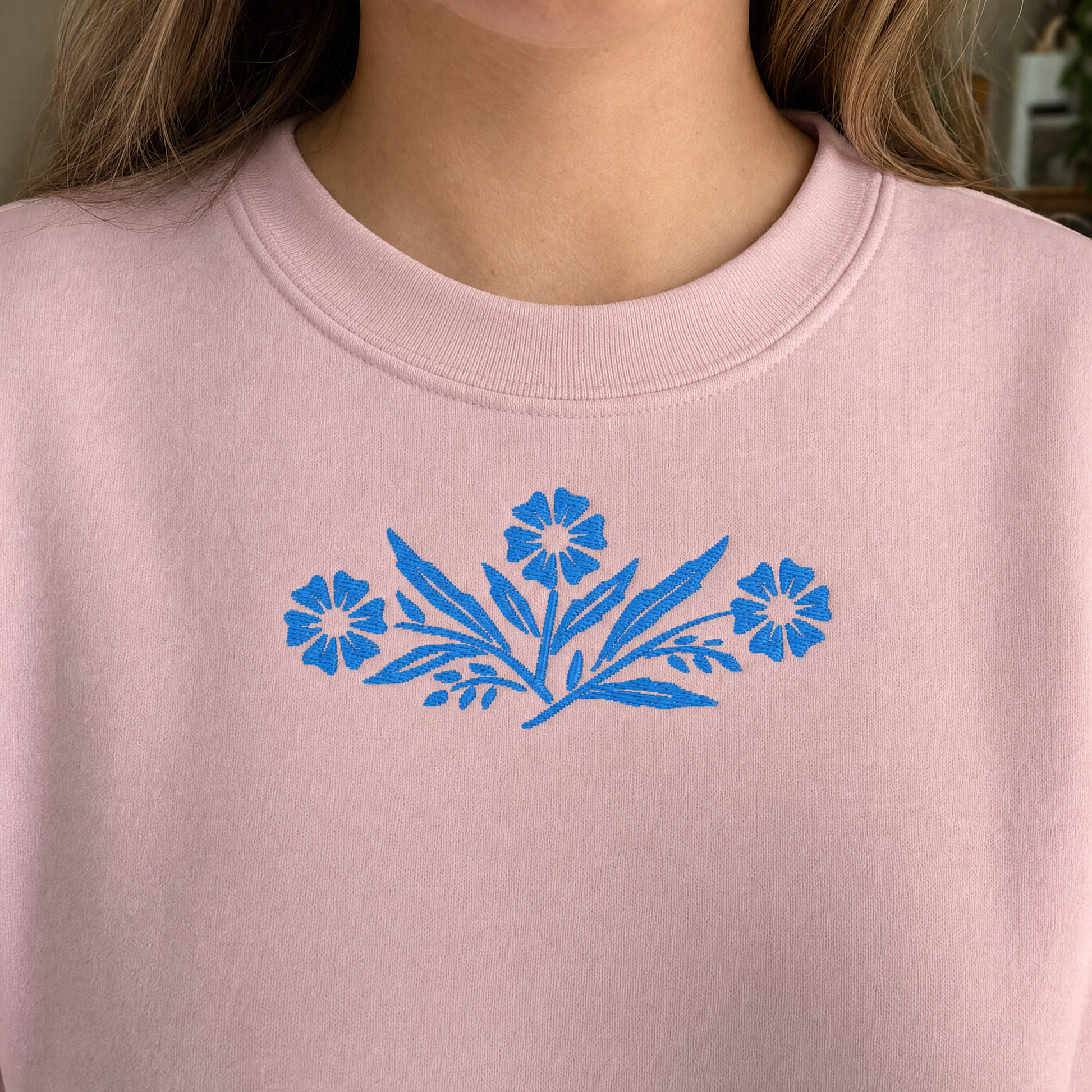 Model wearing the Cornflower Blue Flowers sweatshirt in Light Pink, lifestyle image 2