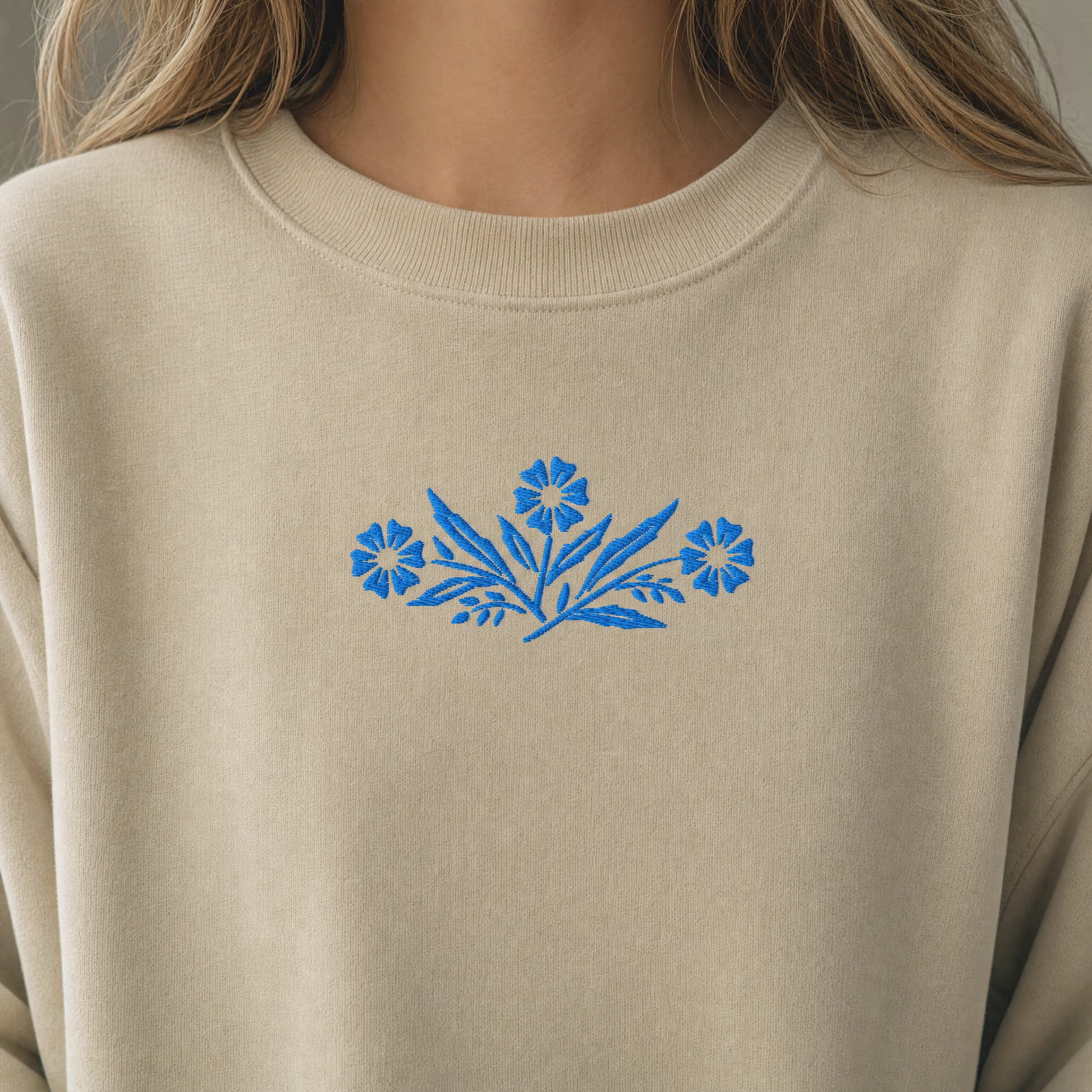Model wearing the Cornflower Blue Flowers sweatshirt in Sand, lifestyle image 2