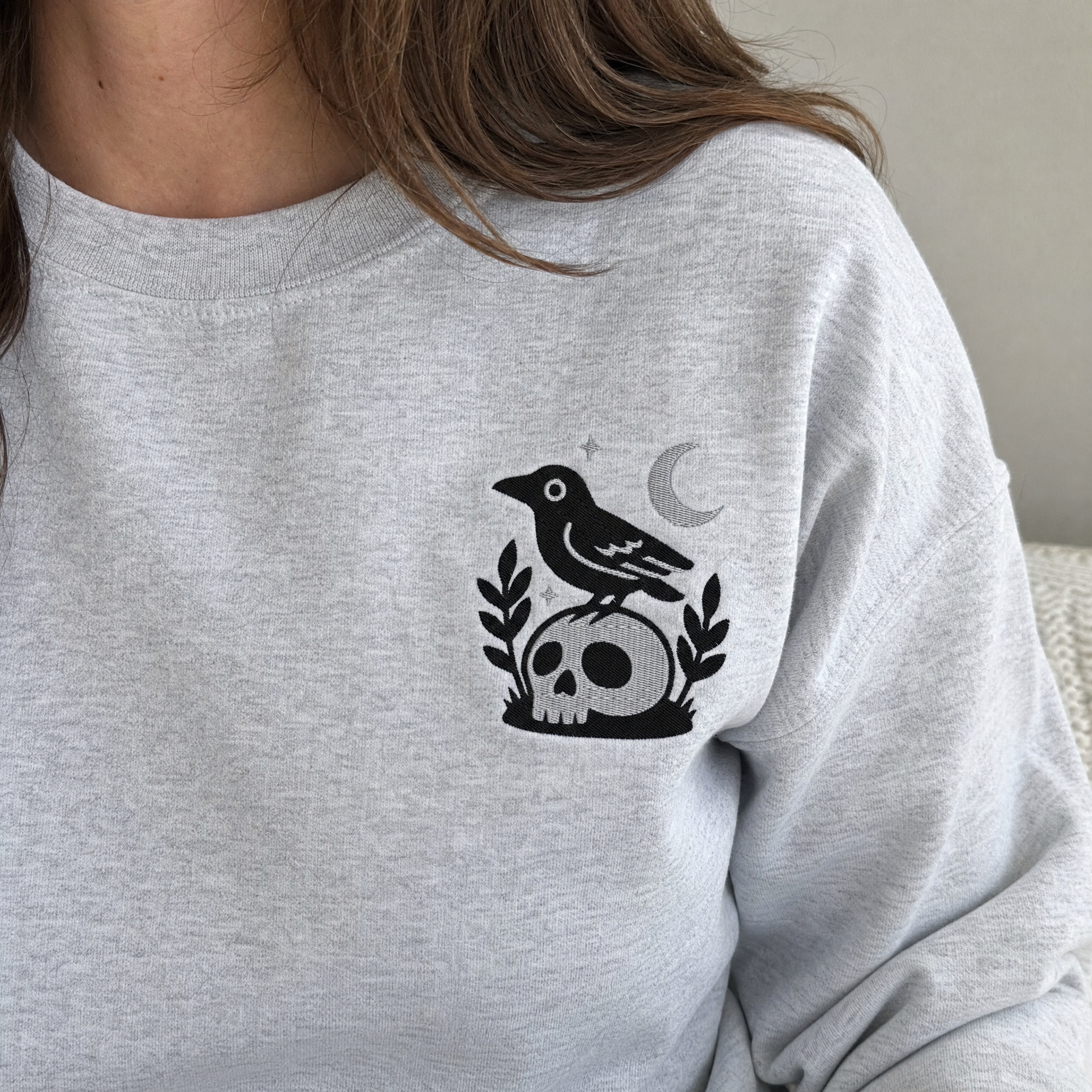 Model wearing the Crow on Skull sweatshirt in Ash, lifestyle image 1