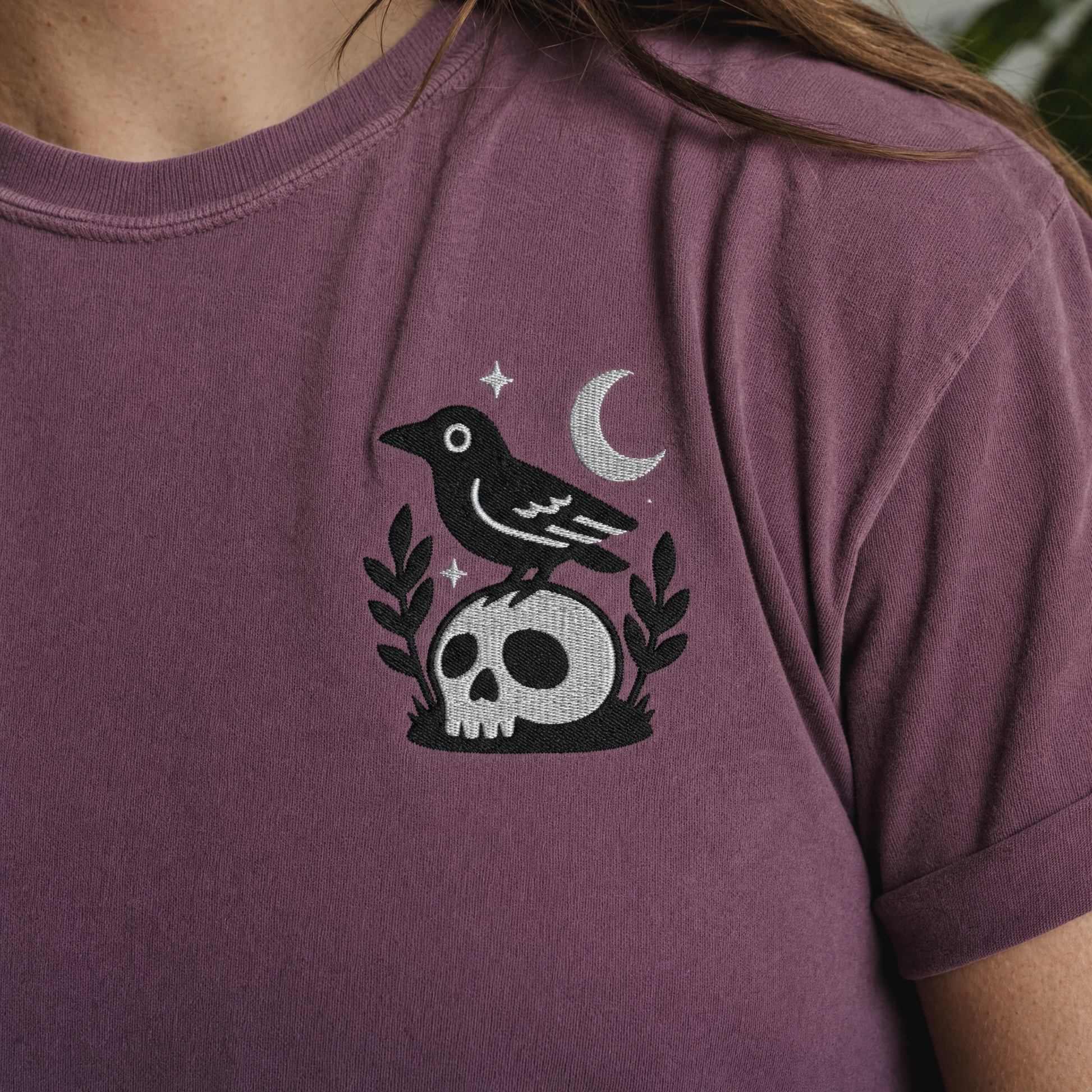 Model wearing the Crow on Skull comfort colors tee in Berry, lifestyle image 2