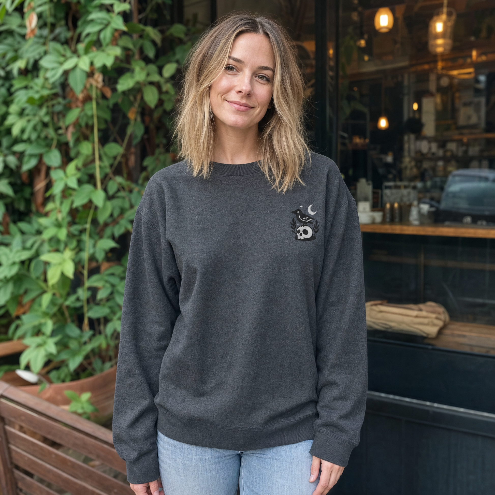 Model wearing the Crow on Skull sweatshirt in Dark Heather, lifestyle image 1