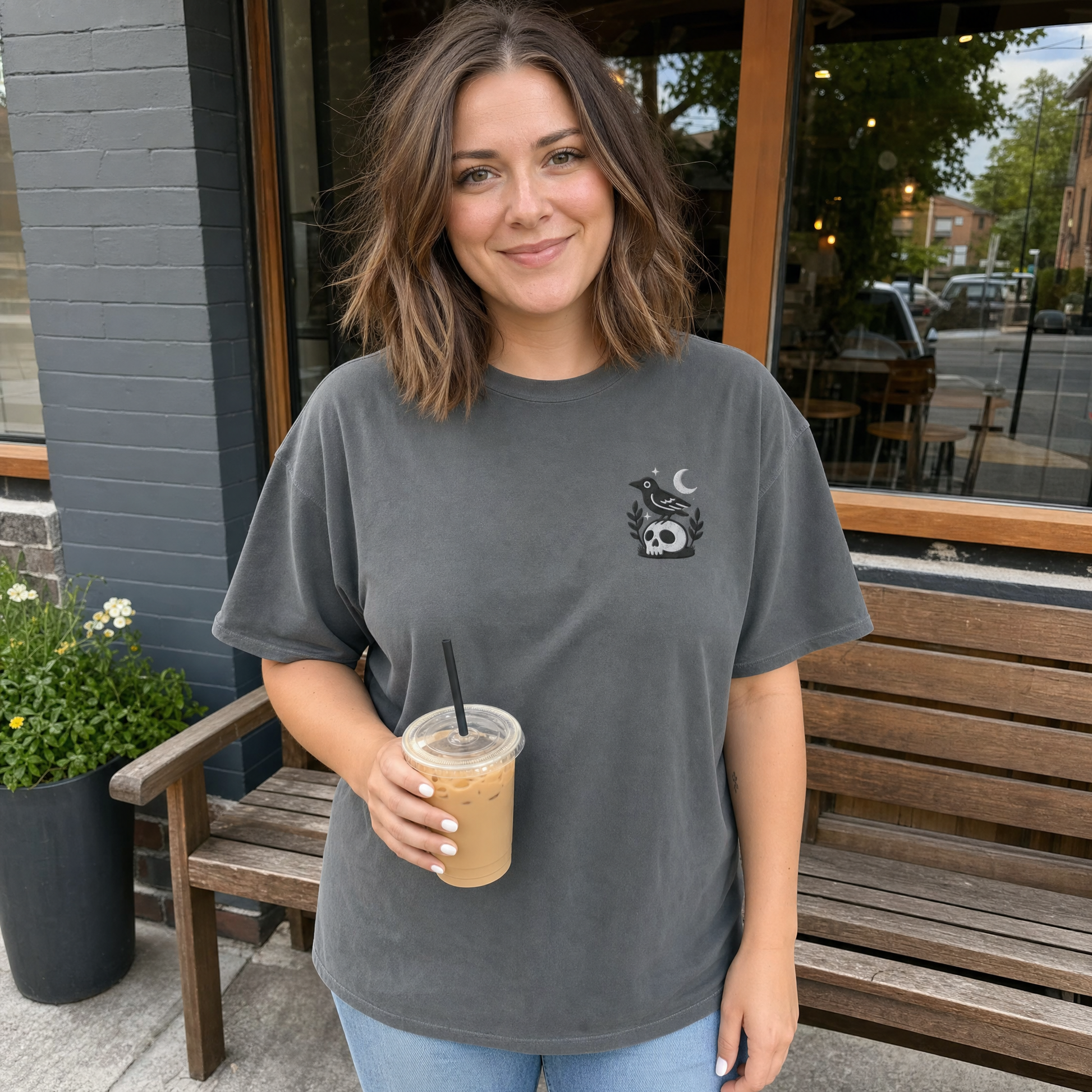 Model wearing the Crow on Skull comfort colors tee in Pepper, lifestyle image 1