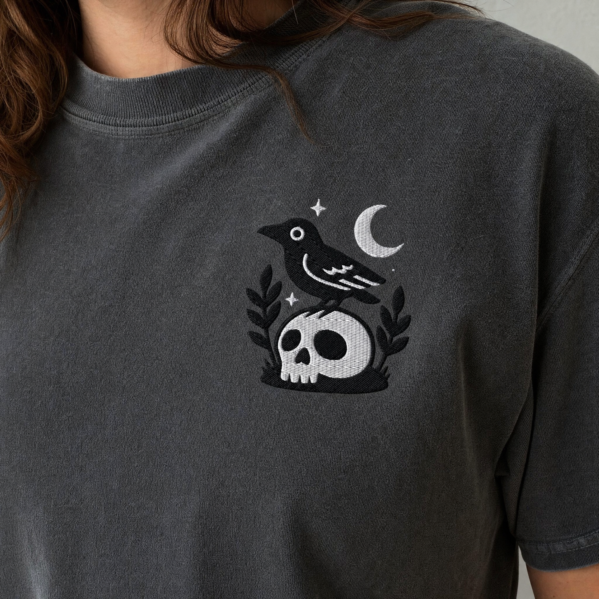 Model wearing the Crow on Skull comfort colors tee in Pepper, lifestyle image 2
