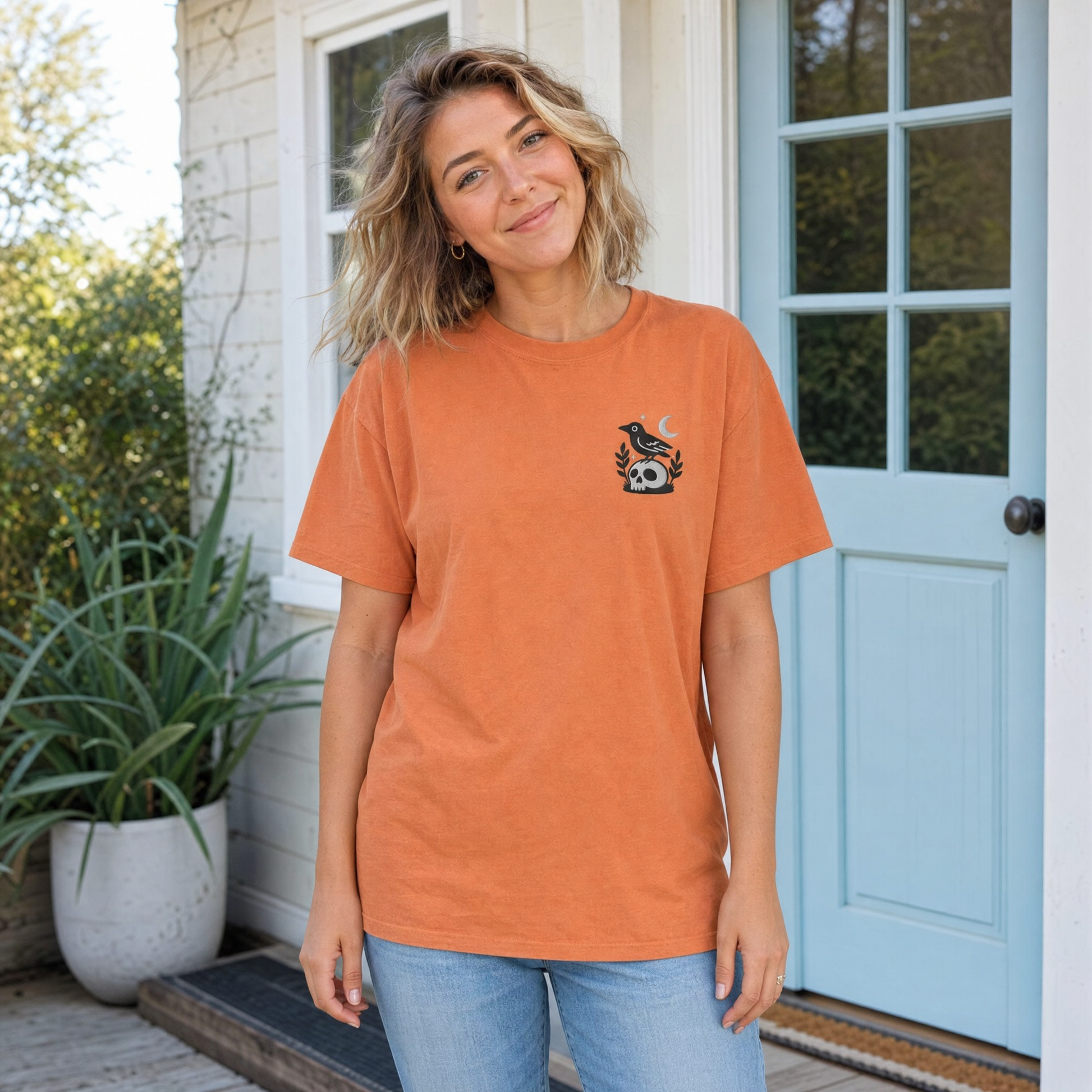 Model wearing the Crow on Skull comfort colors tee in Yam, lifestyle image 1