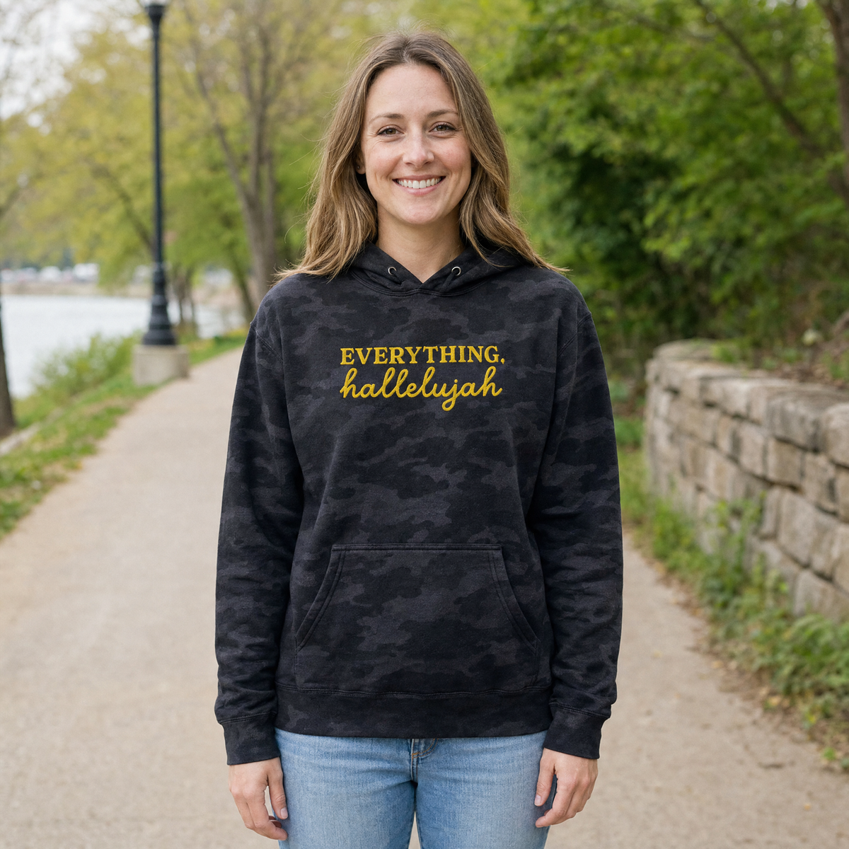 Model wearing the Everything Hallelujah heavyweight hoodie in Black Camo, lifestyle image 1