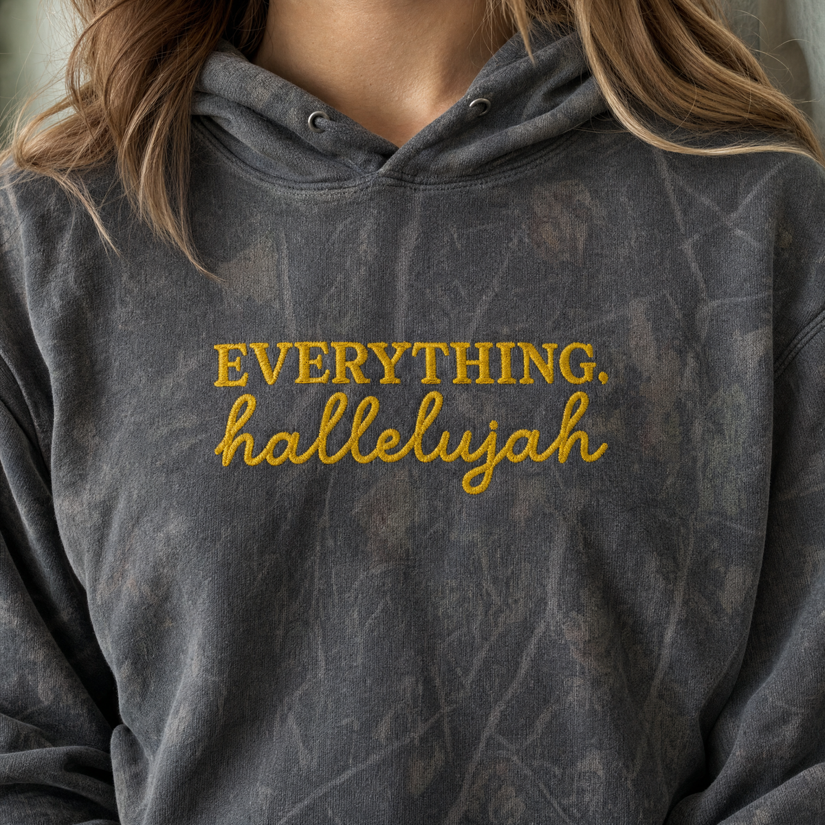 Model wearing the Everything Hallelujah heavyweight hoodie in Dark Tree Camo, lifestyle image 1