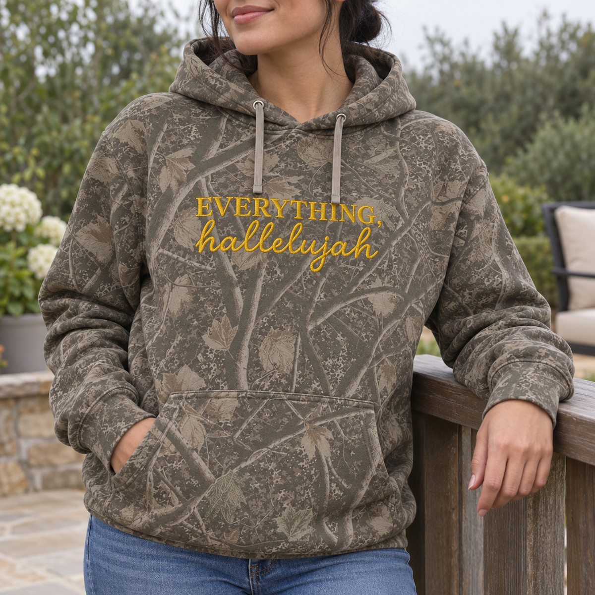 Model wearing the Everything Hallelujah heavyweight hoodie in Light Tree Camo, lifestyle image 2