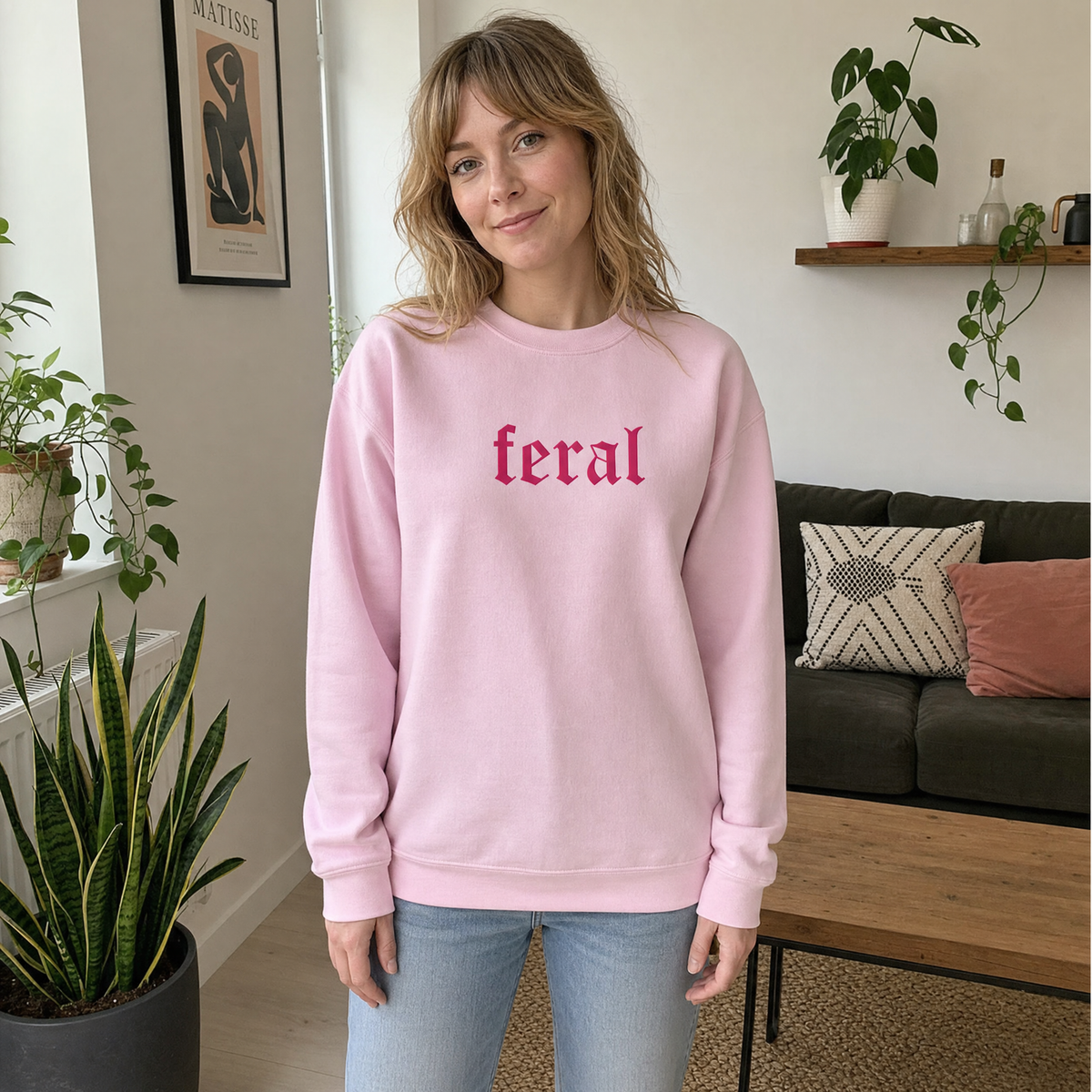 Model wearing the Feral sweatshirt in Light Pink, lifestyle image 1