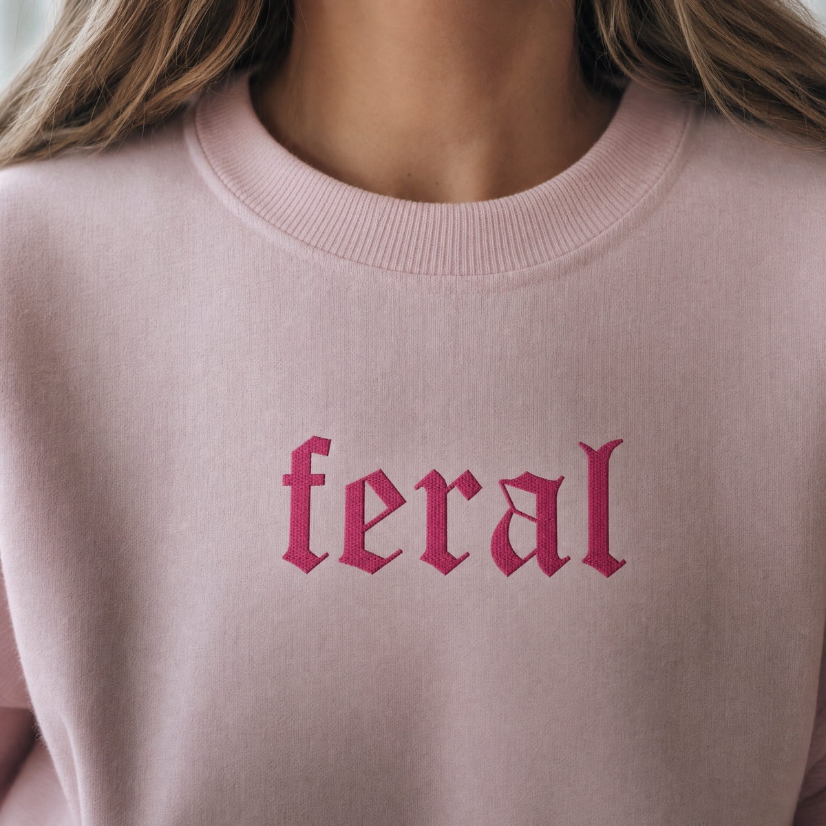 Model wearing the Feral sweatshirt in Light Pink, lifestyle image 2