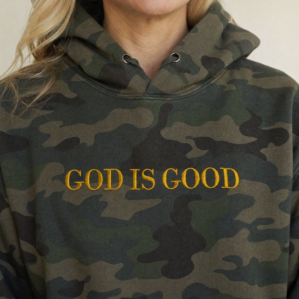 Model wearing the God Is Good heavyweight hoodie in Forest Camo, lifestyle image 2