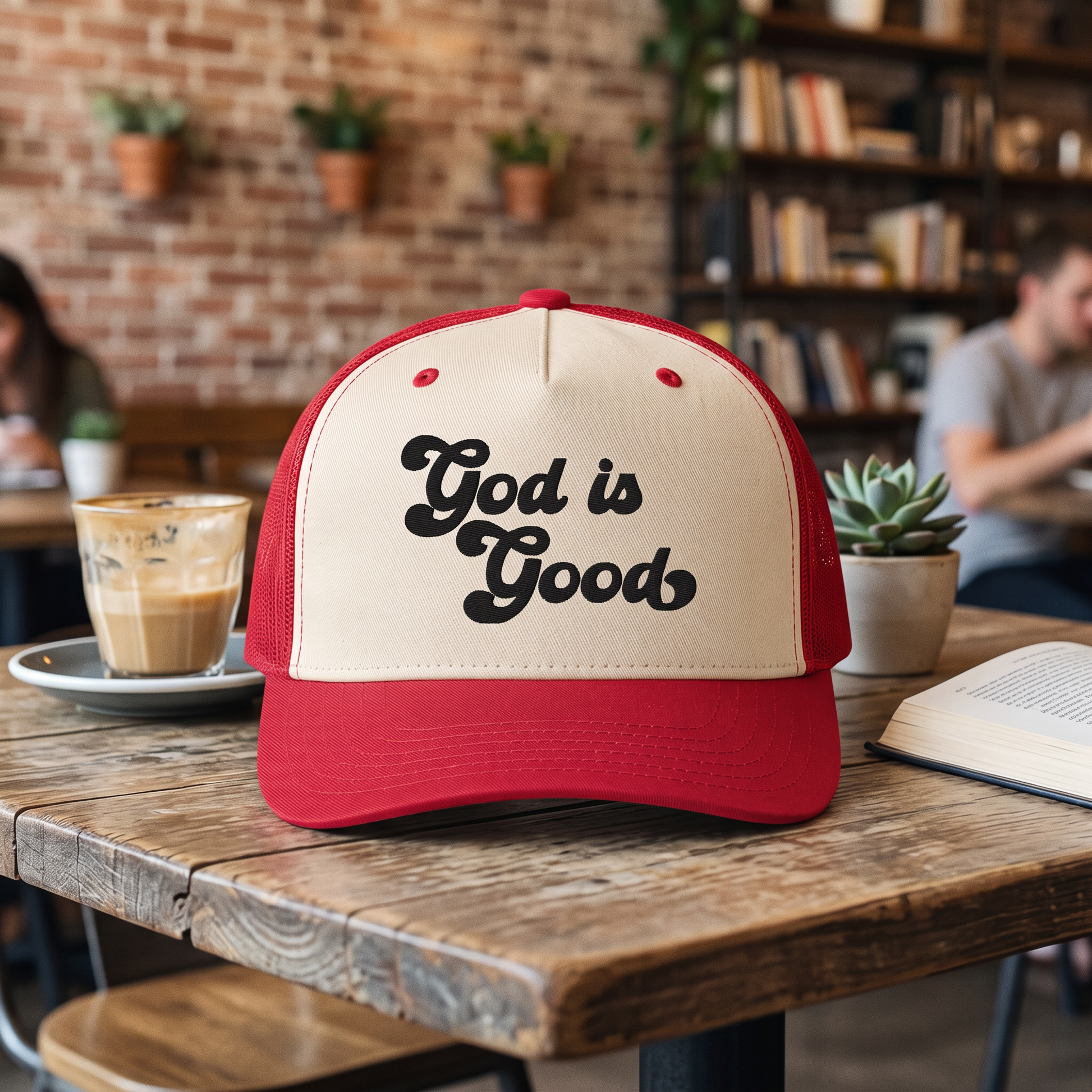 God is Good embroidered hat in Red/natural resting on a flat surface