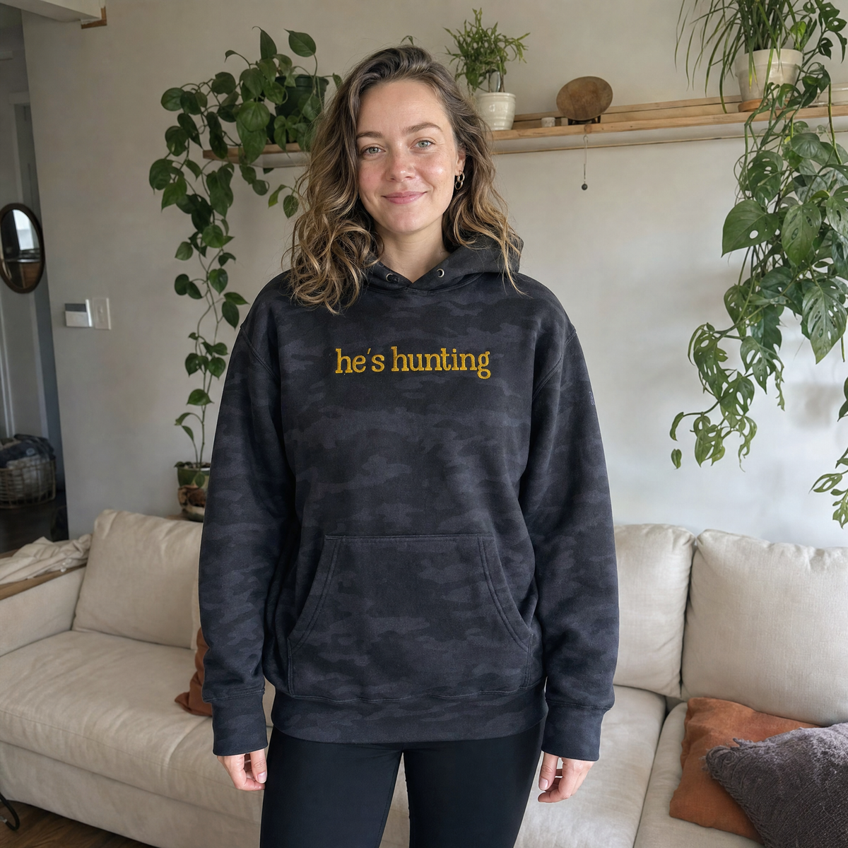 Model wearing the He's Hunting heavyweight hoodie in Black Camo, lifestyle image 1