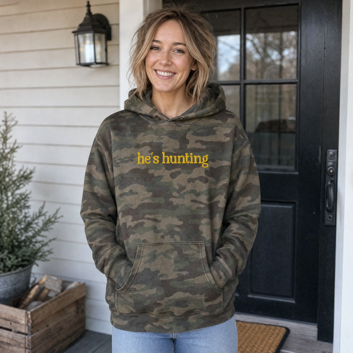 Model wearing the He's Hunting heavyweight hoodie in Forest Camo, lifestyle image 1
