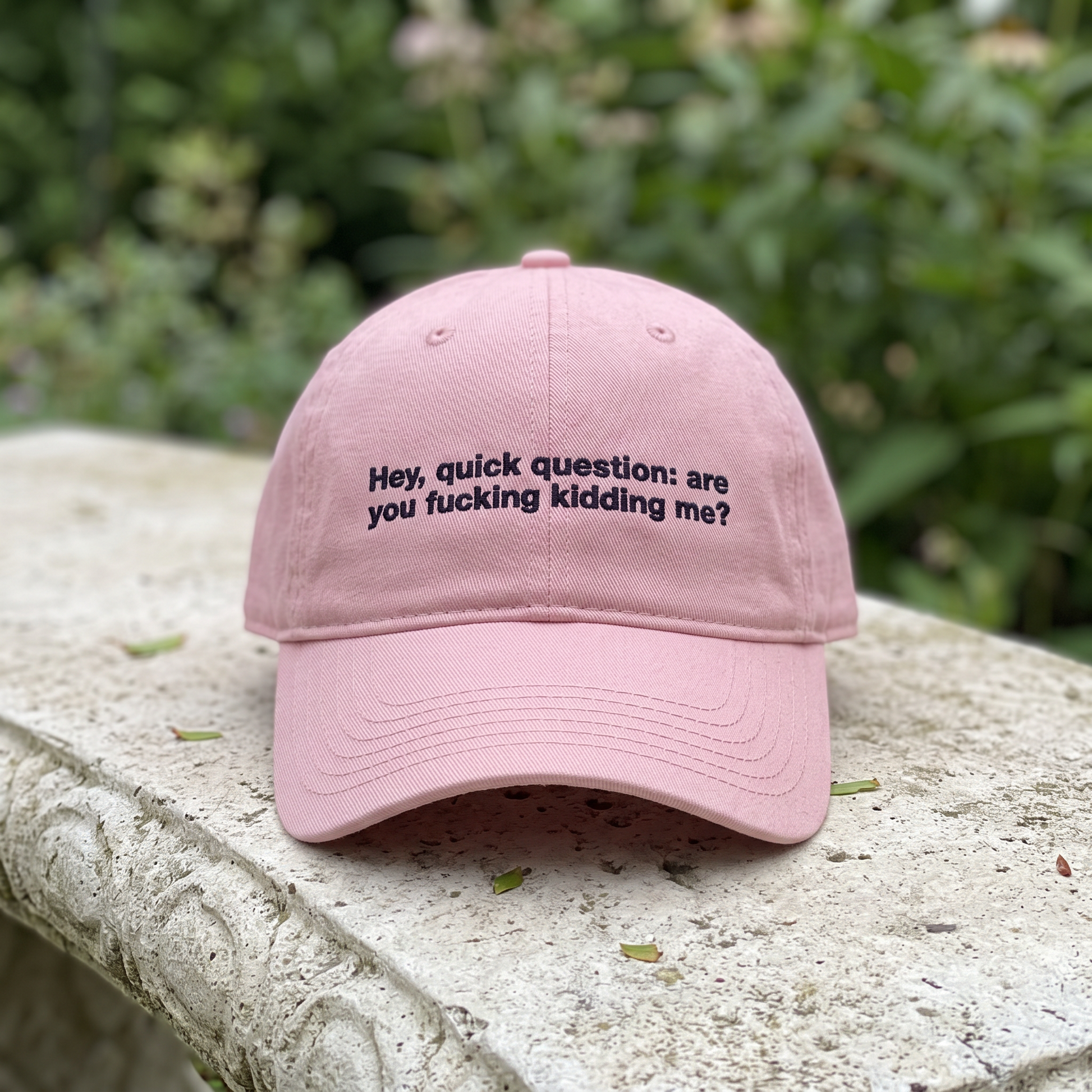 Hey Quick Question embroidered hat in Dusty Rose resting on a flat surface, lifestyle image 2