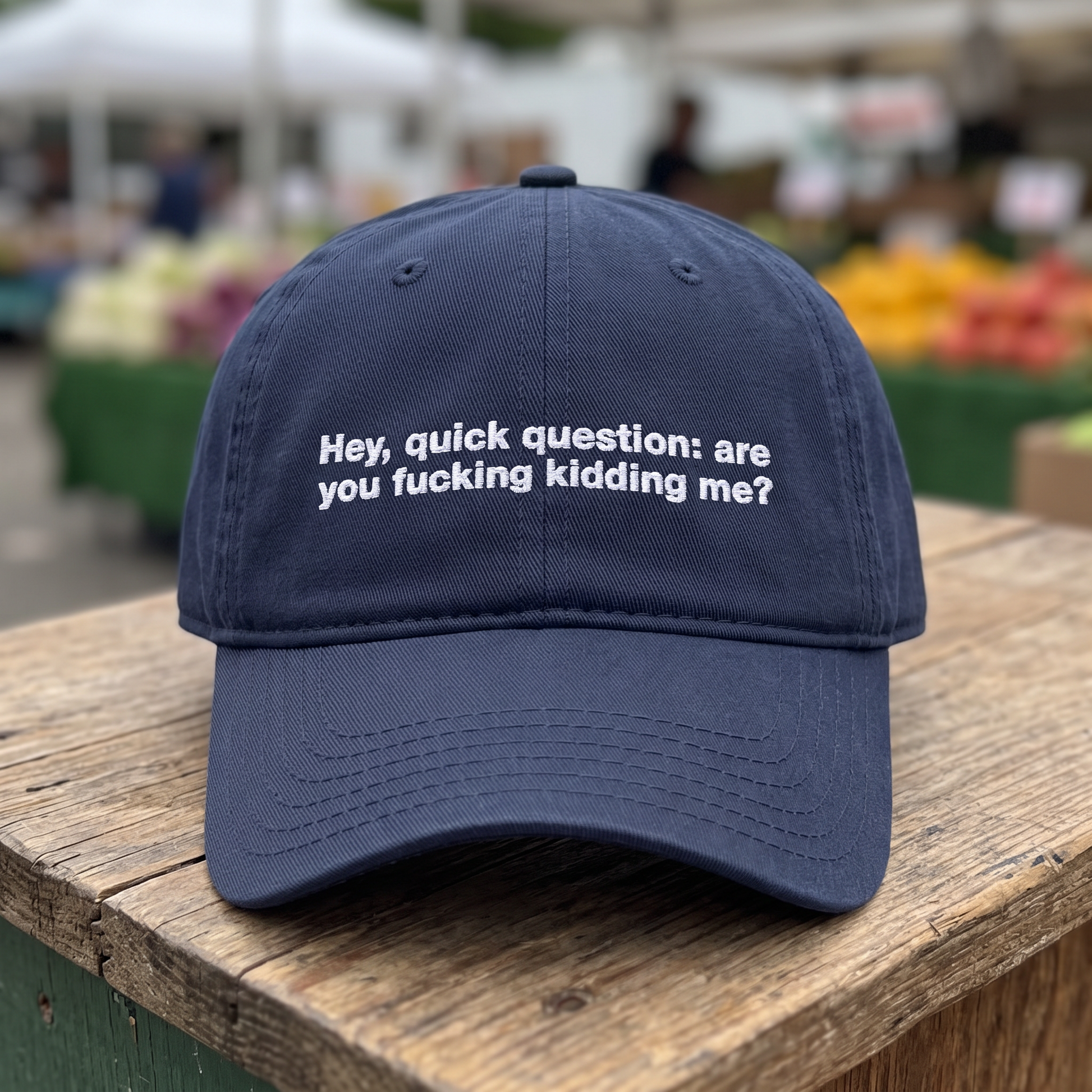 Hey Quick Question embroidered hat in Navy resting on a flat surface, lifestyle image 1