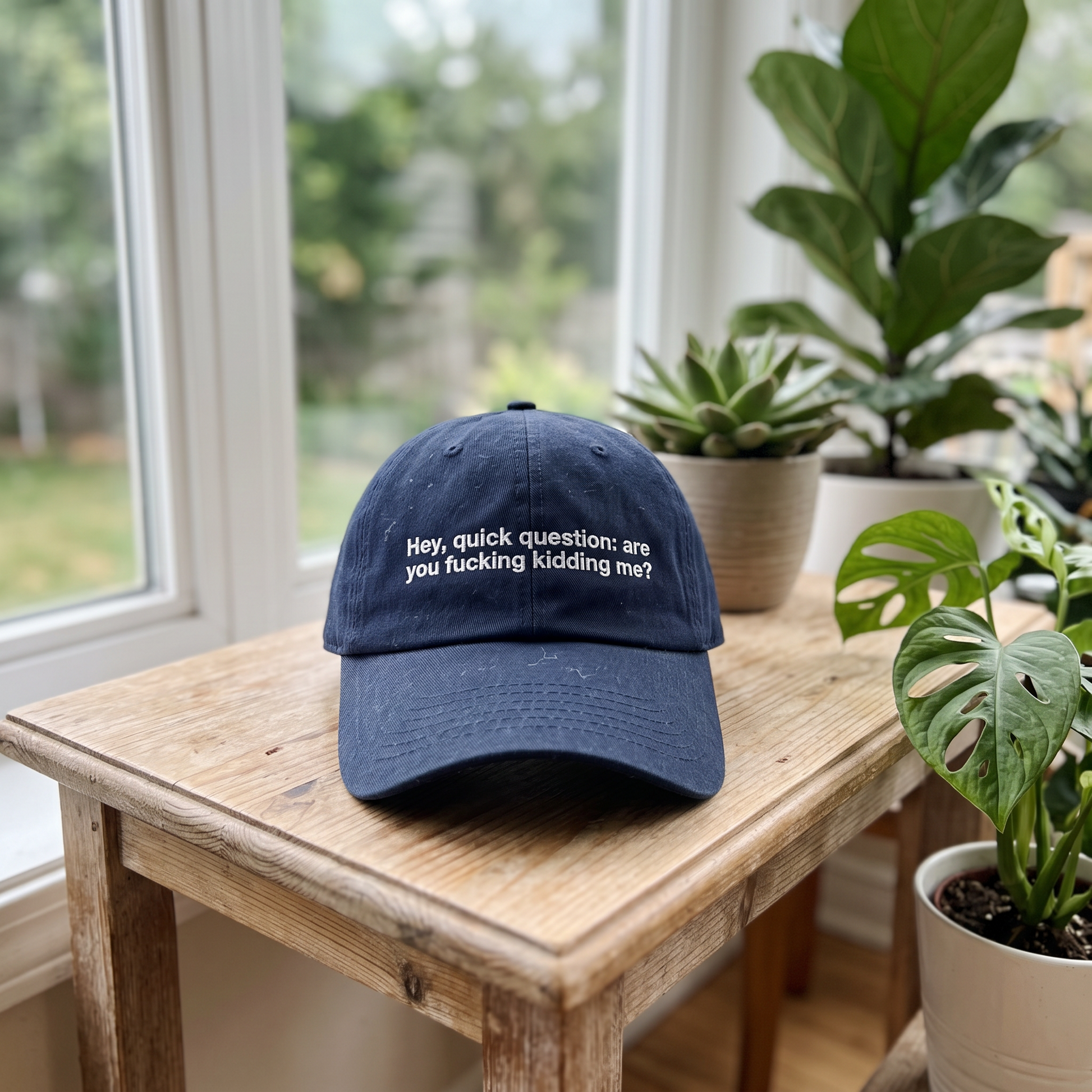 Hey Quick Question embroidered hat in Navy resting on a flat surface, lifestyle image 2