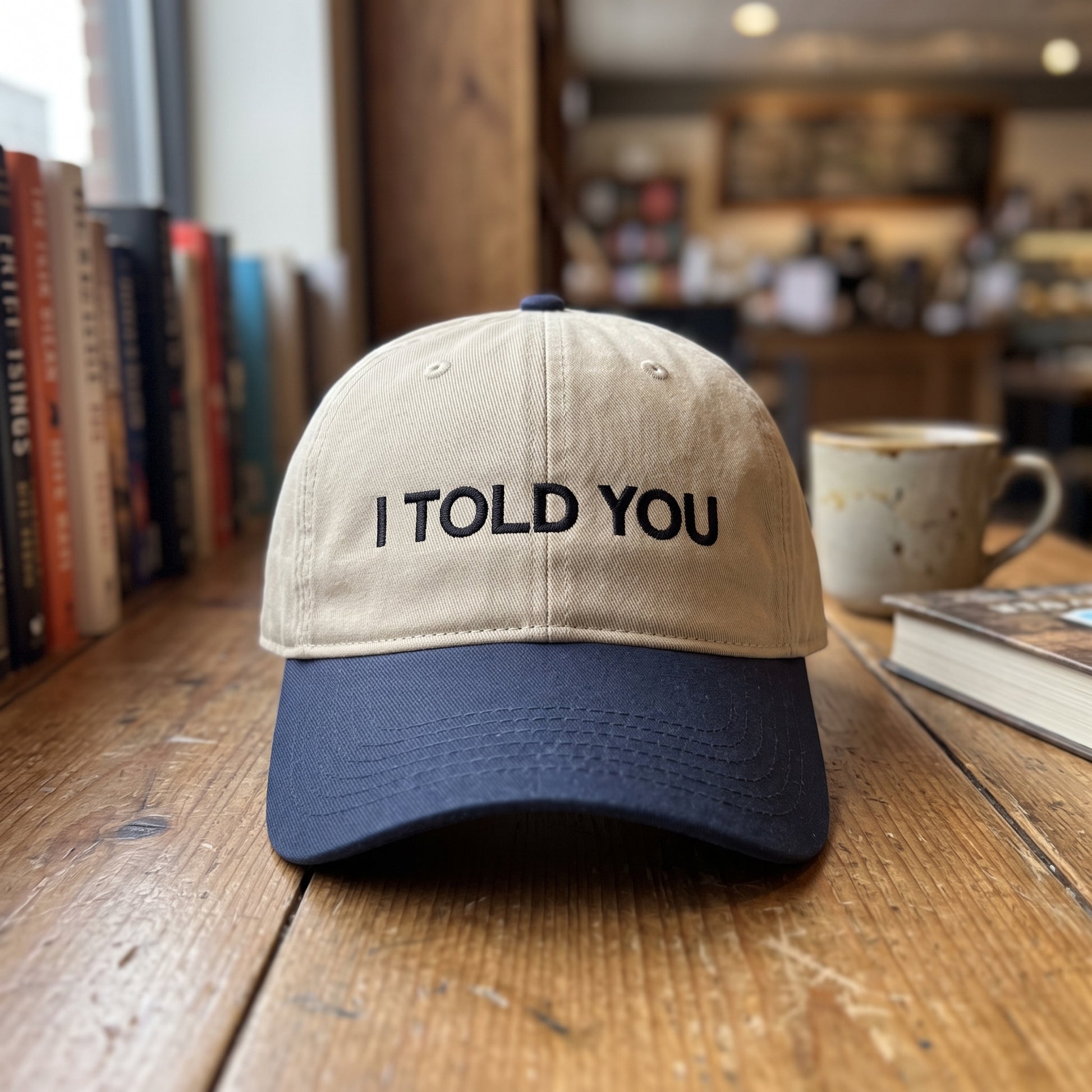 I Told You embroidered hat in Navy/khaki resting on a flat surface, lifestyle image 2