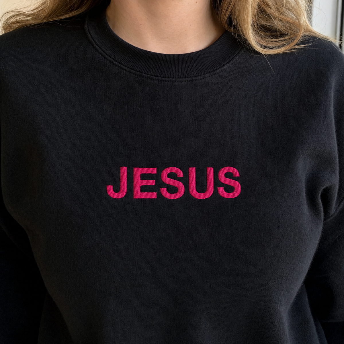 Model wearing the JESUS Pink Lettering Sweatshirt sweatshirt in Black, lifestyle image 1