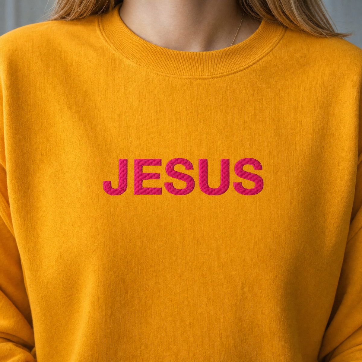 Model wearing the JESUS Pink Lettering Sweatshirt sweatshirt in Gold, lifestyle image 2