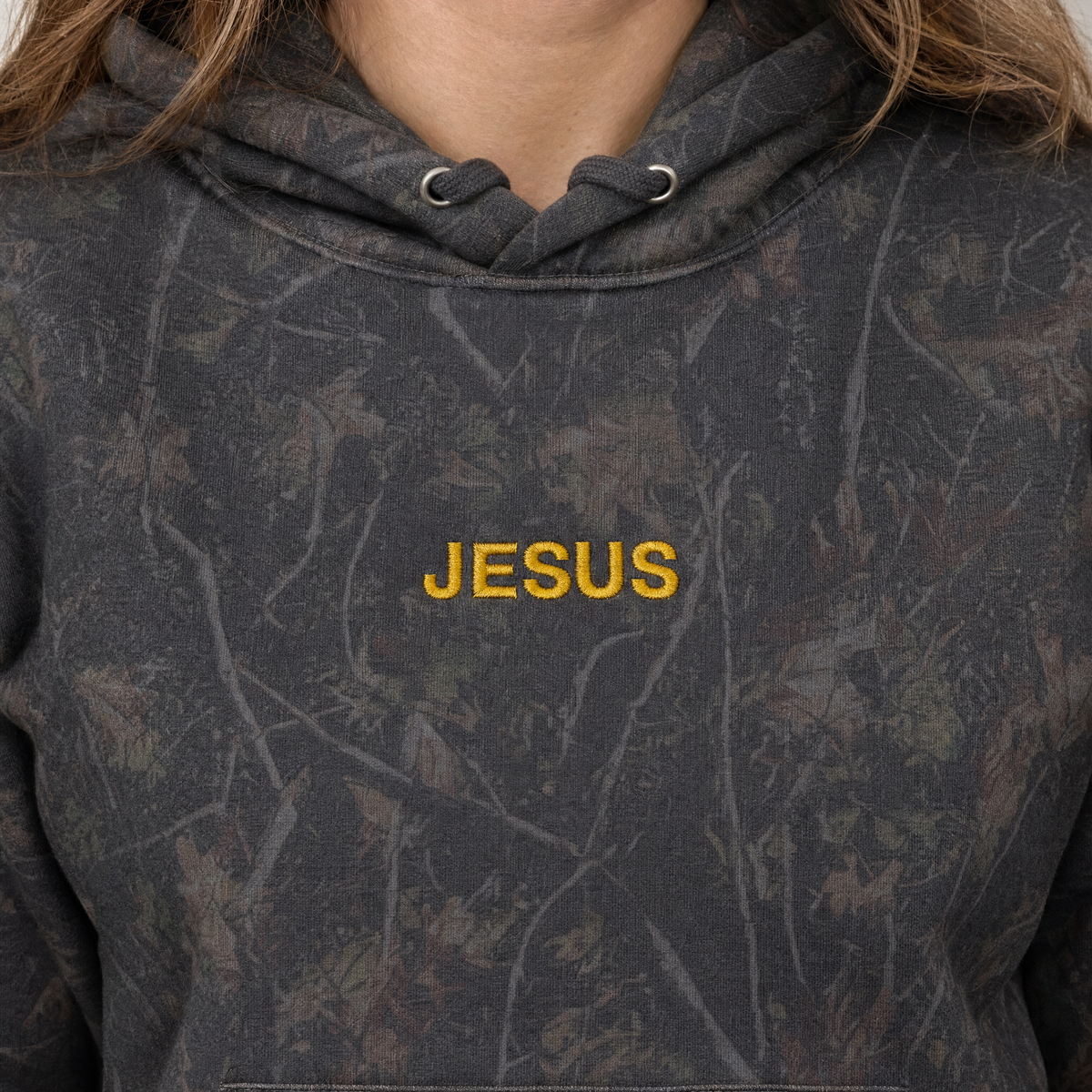 Model wearing the JESUS Text heavyweight hoodie in Dark Tree Camo, lifestyle image 2
