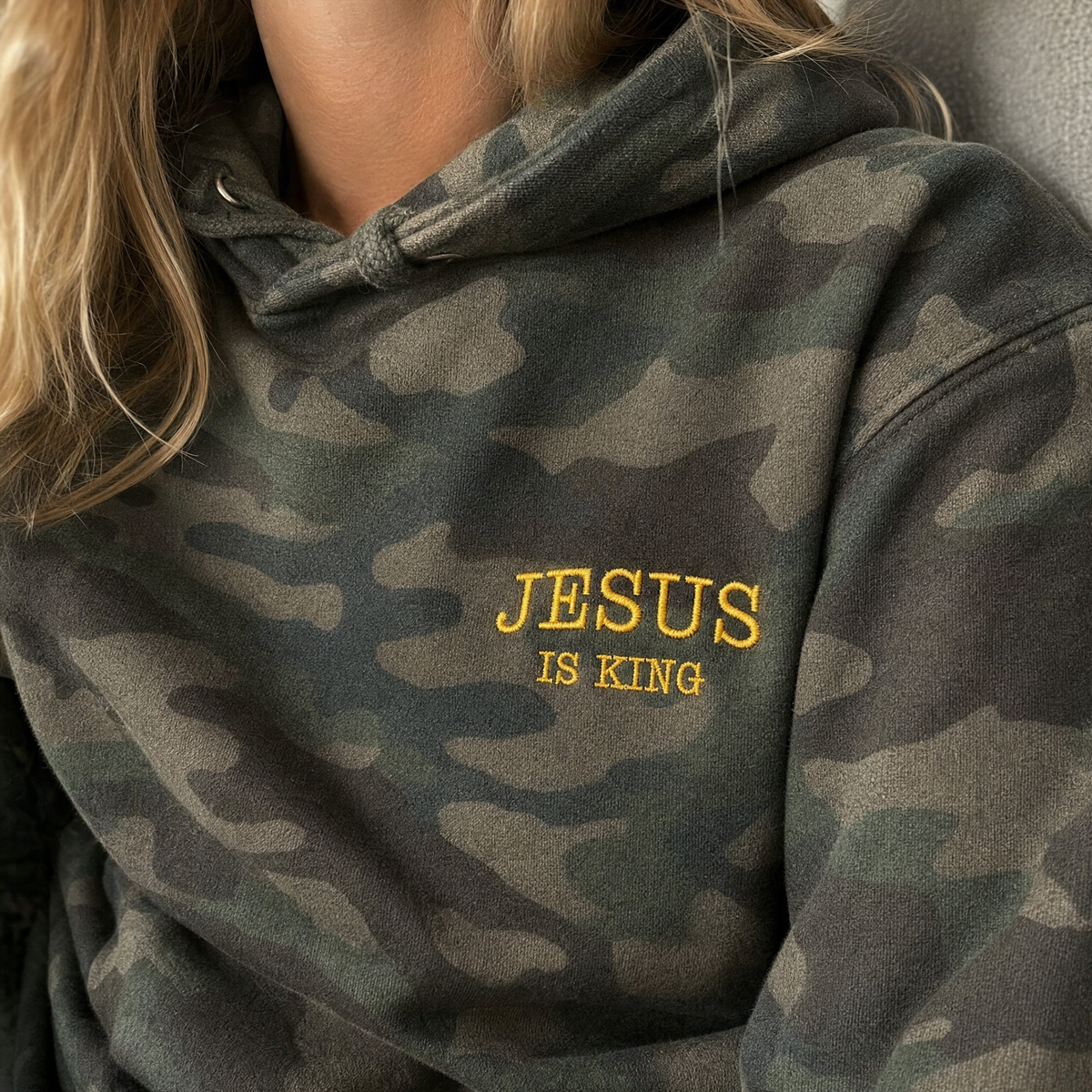 Model wearing the Jesus Is King heavyweight hoodie in Forest Camo, lifestyle image 2