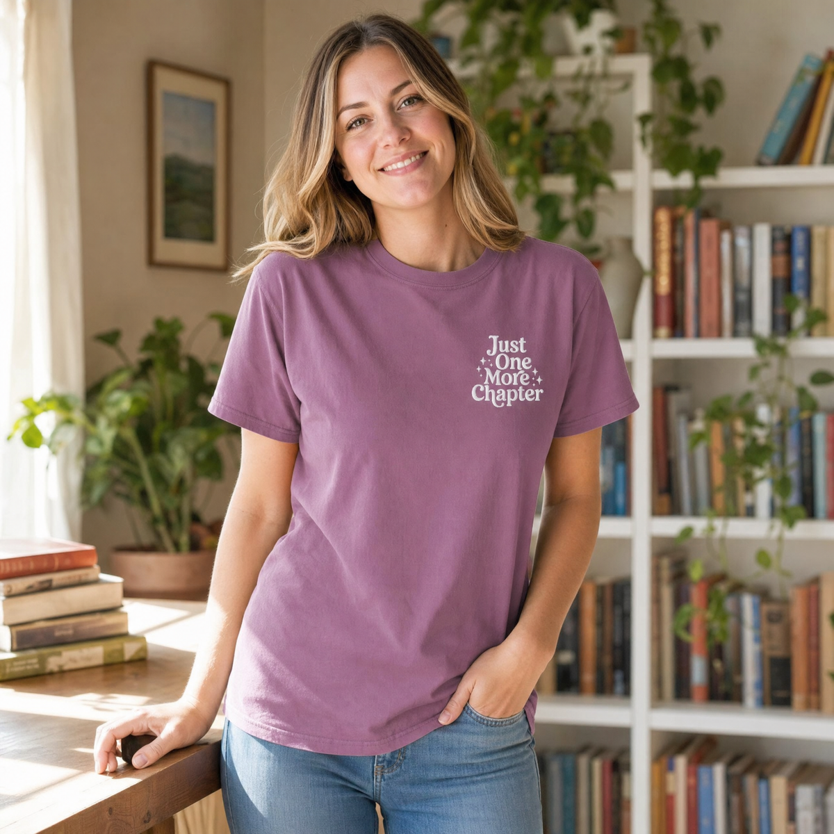 Model wearing the Just One More Chapter comfort colors tee in Berry, lifestyle image 1