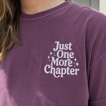 Model wearing the Just One More Chapter comfort colors tee in Berry, lifestyle image 2