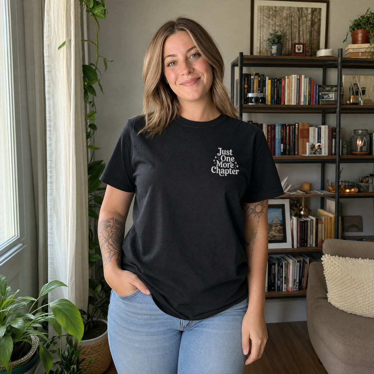 Model wearing the Just One More Chapter comfort colors tee in Black, lifestyle image 1
