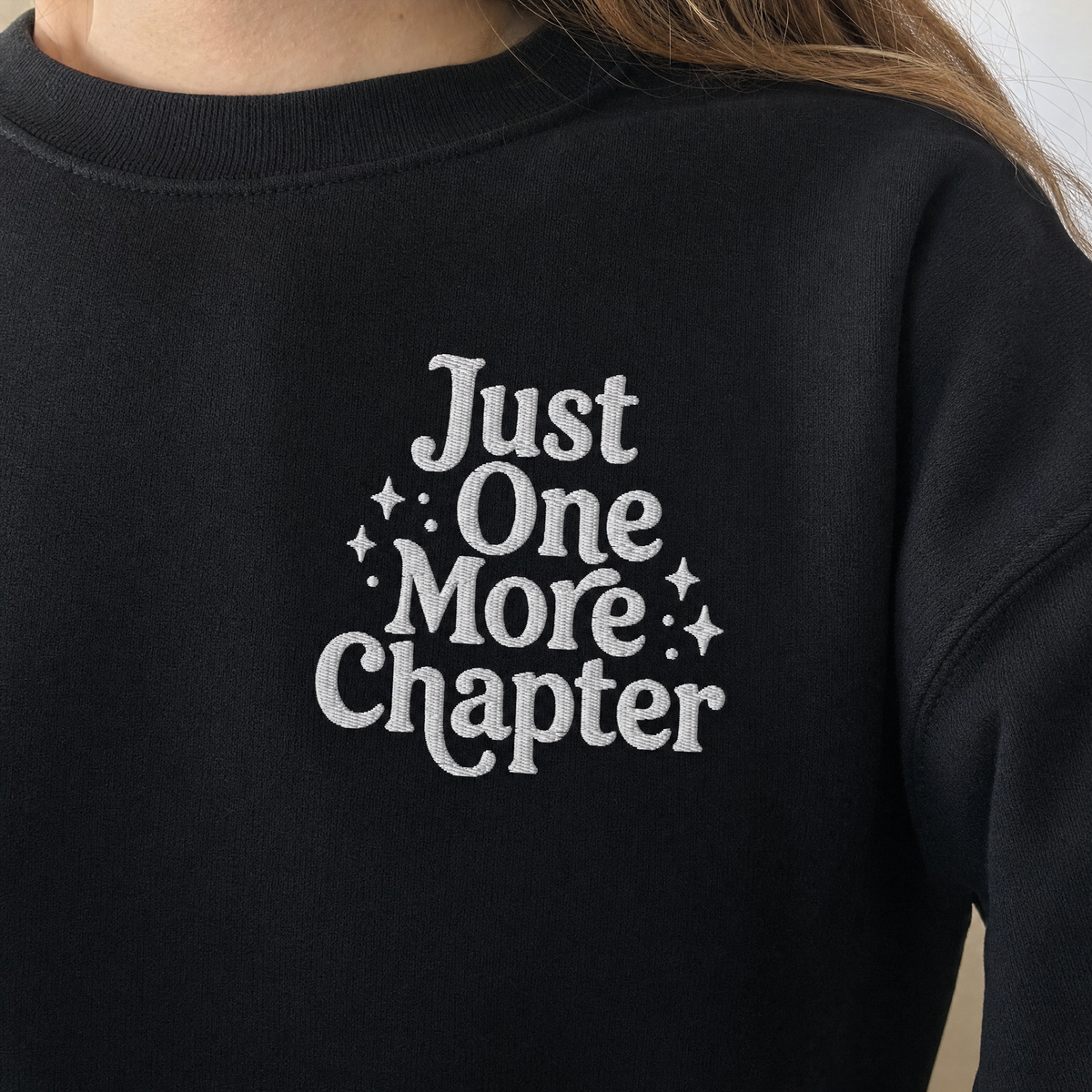 Model wearing the Just One More Chapter sweatshirt in Black, lifestyle image 2