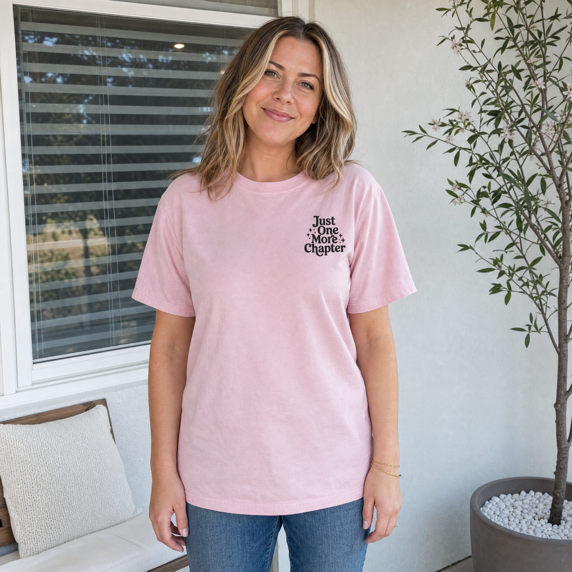 Model wearing the Just One More Chapter comfort colors tee in Blossom, lifestyle image 1