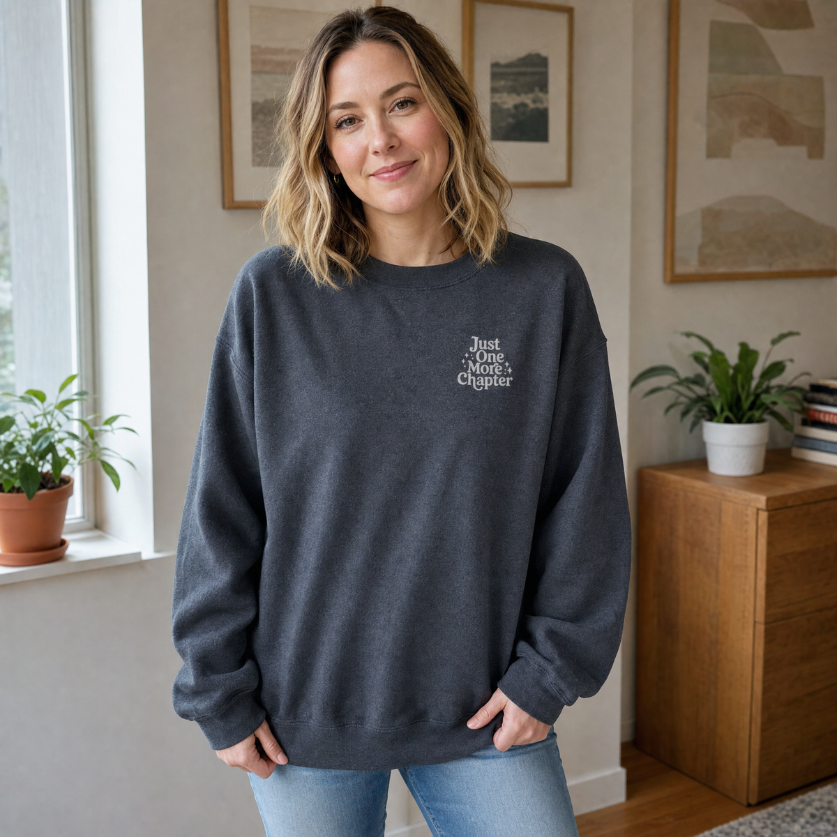 Model wearing the Just One More Chapter sweatshirt in Dark Heather, lifestyle image 1