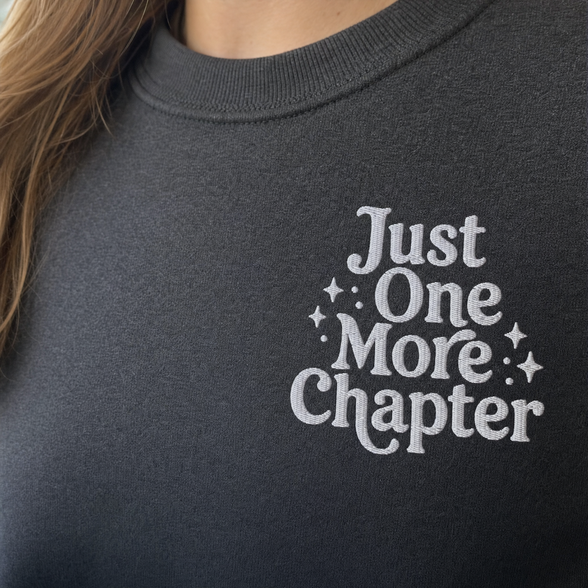 Model wearing the Just One More Chapter sweatshirt in Dark Heather, lifestyle image 2