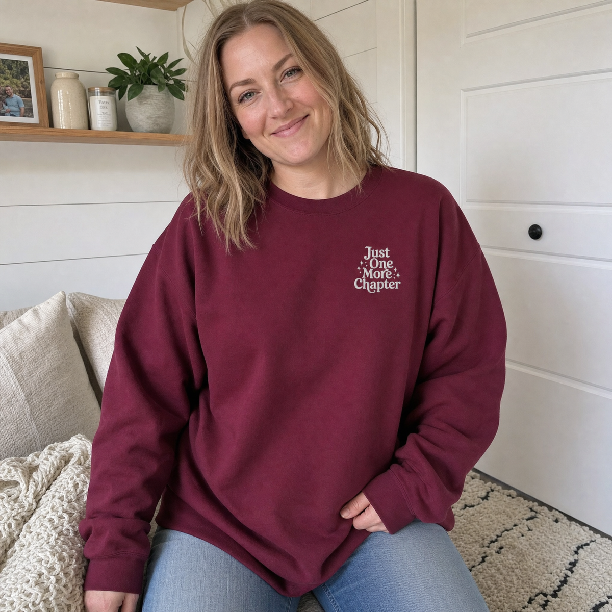 Model wearing the Just One More Chapter sweatshirt in Maroon, lifestyle image 1
