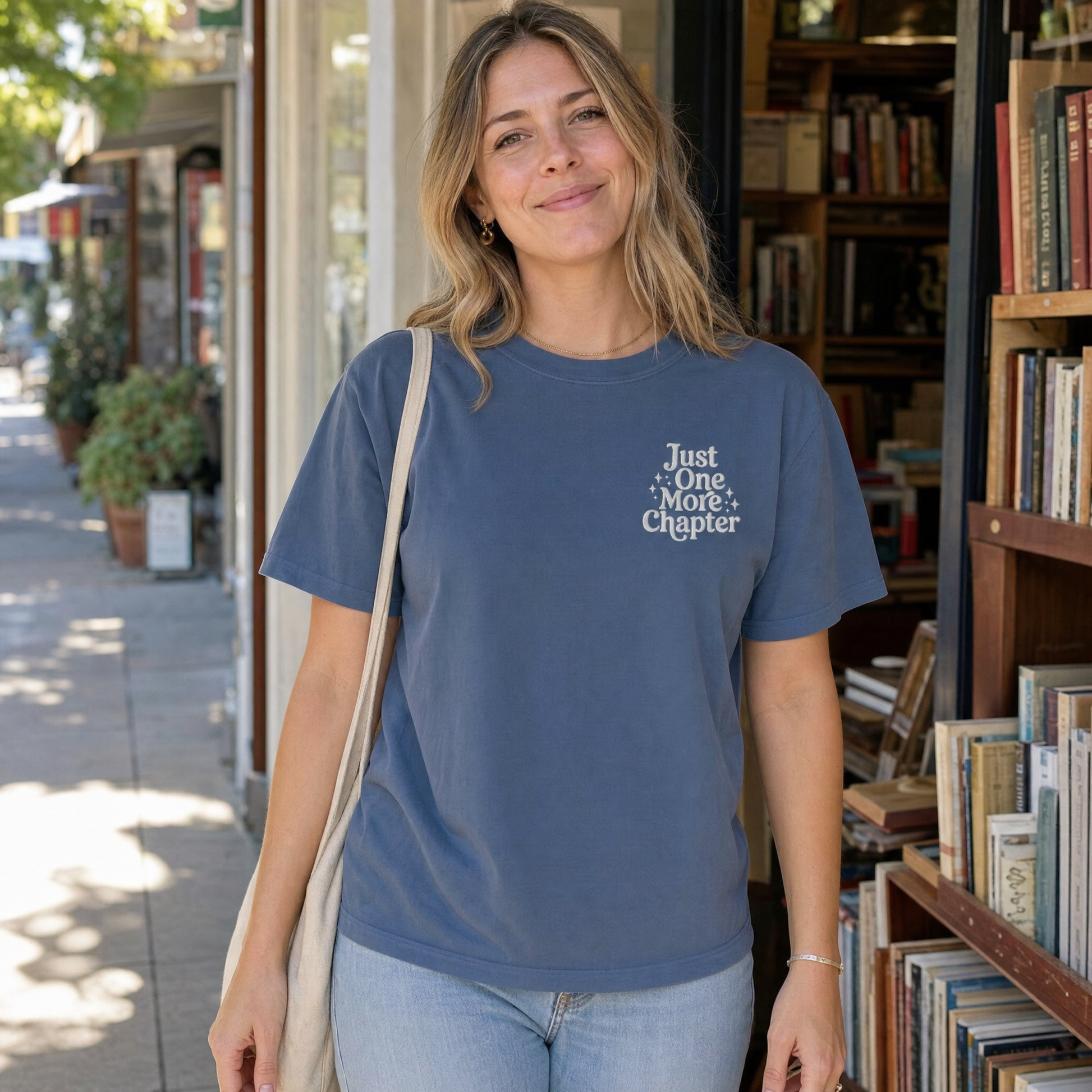 Model wearing the Just One More Chapter comfort colors tee in Midnight, lifestyle image 1