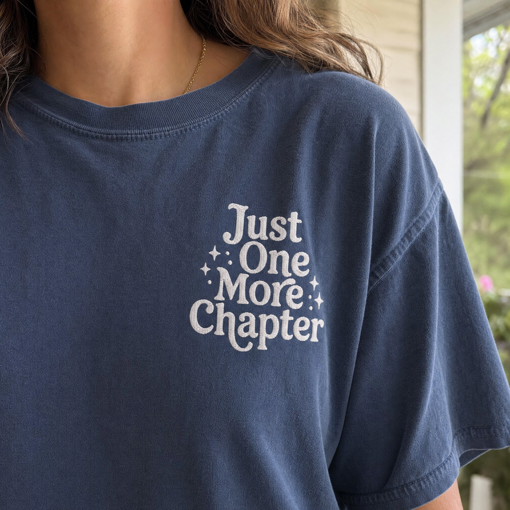 Model wearing the Just One More Chapter comfort colors tee in Midnight, lifestyle image 2