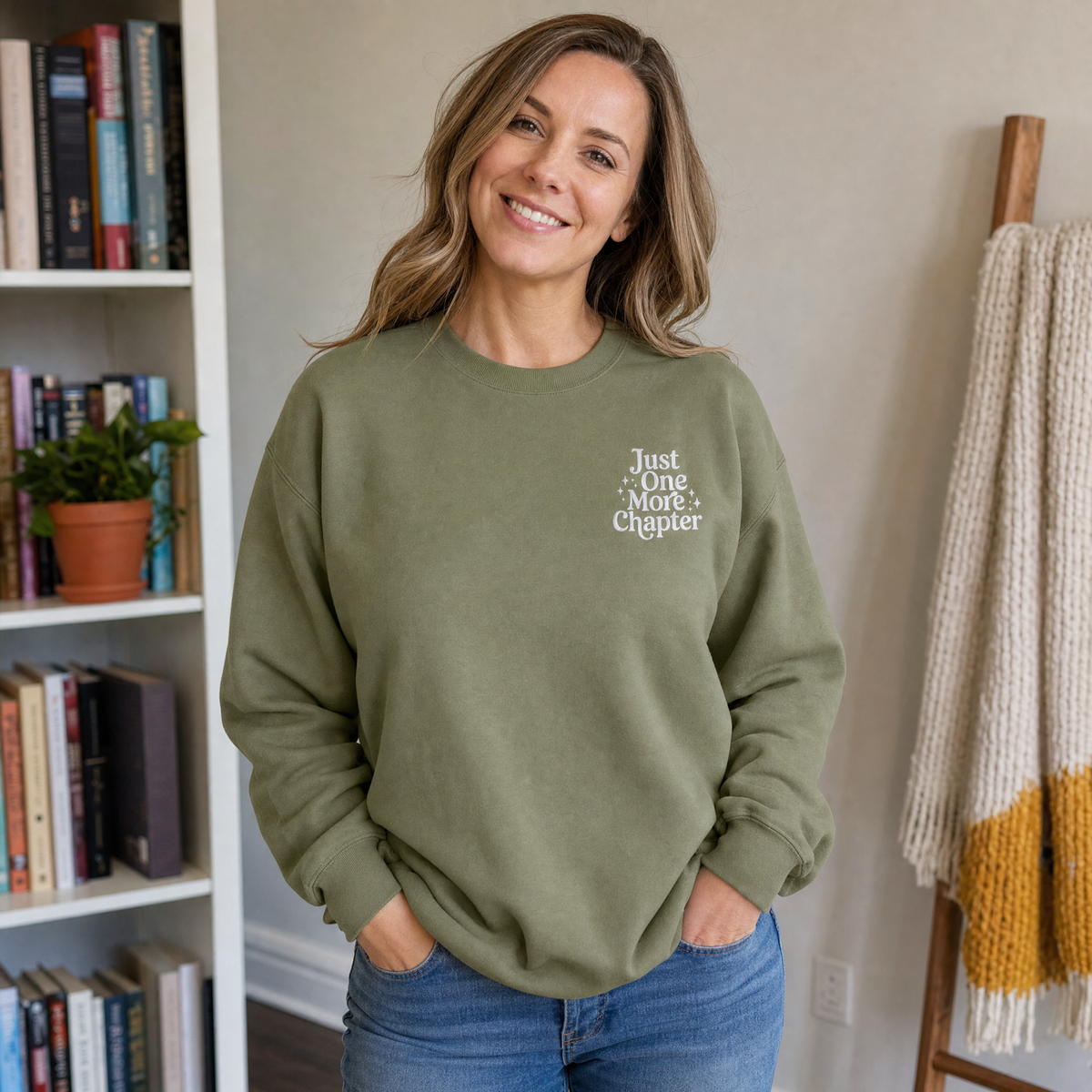 Model wearing the Just One More Chapter sweatshirt in Military Green, lifestyle image 1