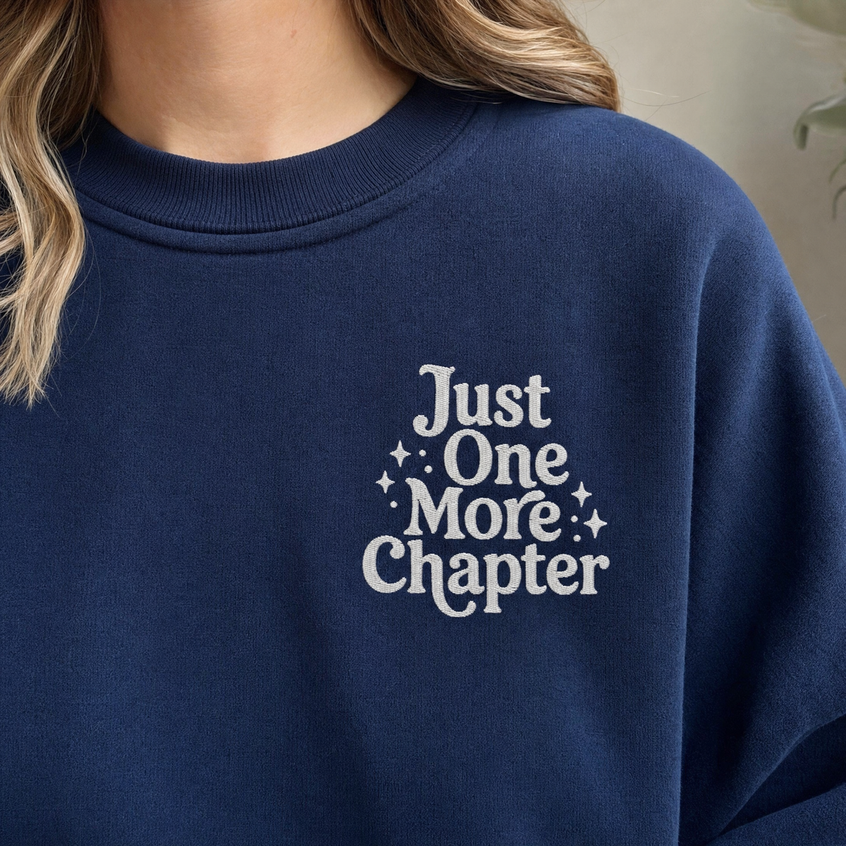 Model wearing the Just One More Chapter sweatshirt in Navy, lifestyle image 1