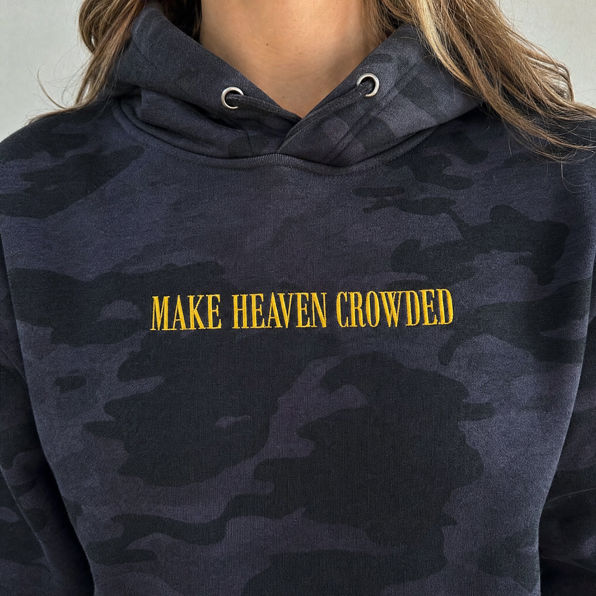 Model wearing the Make Heaven Crowded heavyweight hoodie in Black Camo, lifestyle image 2