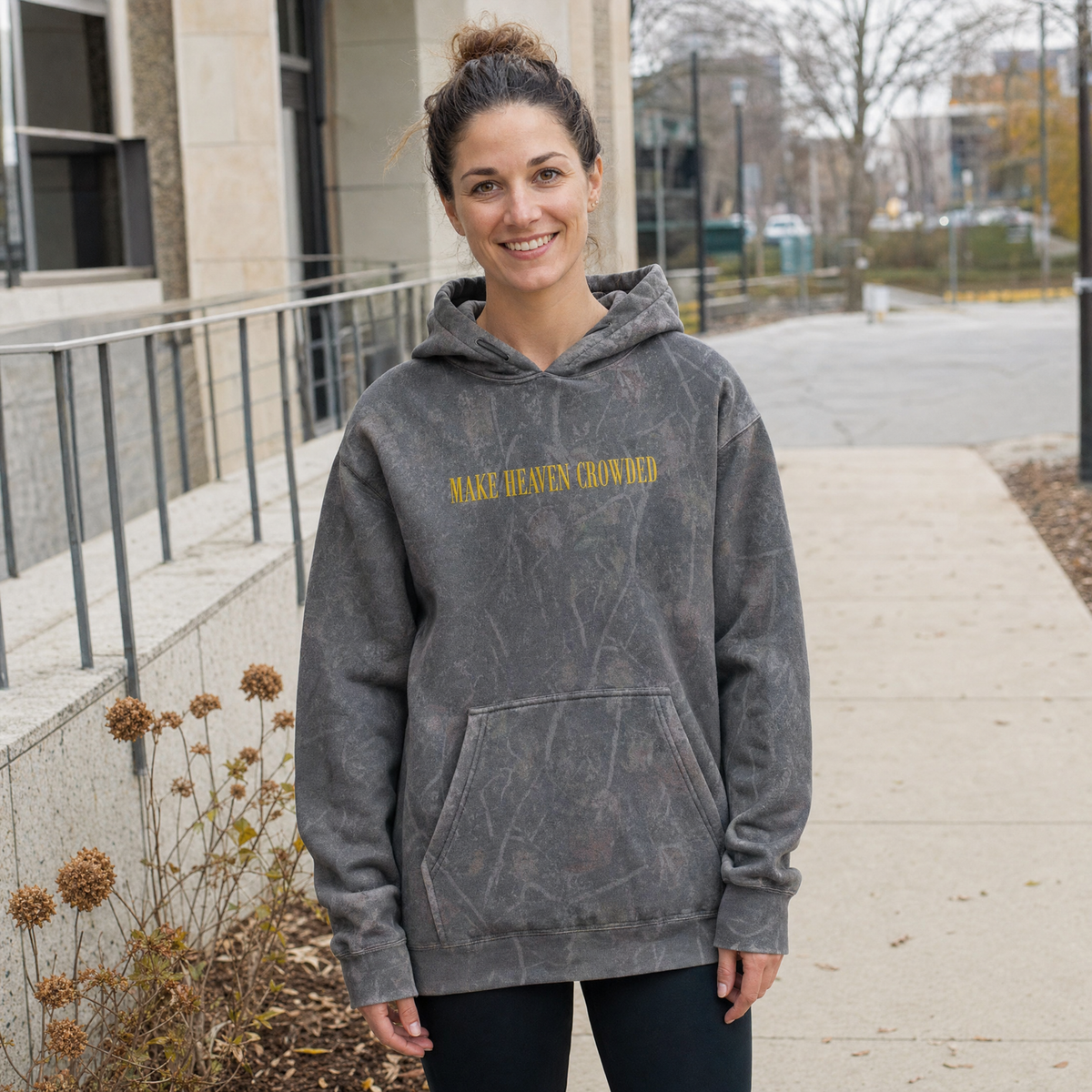 Model wearing the Make Heaven Crowded heavyweight hoodie in Dark Tree Camo, cover image 1
