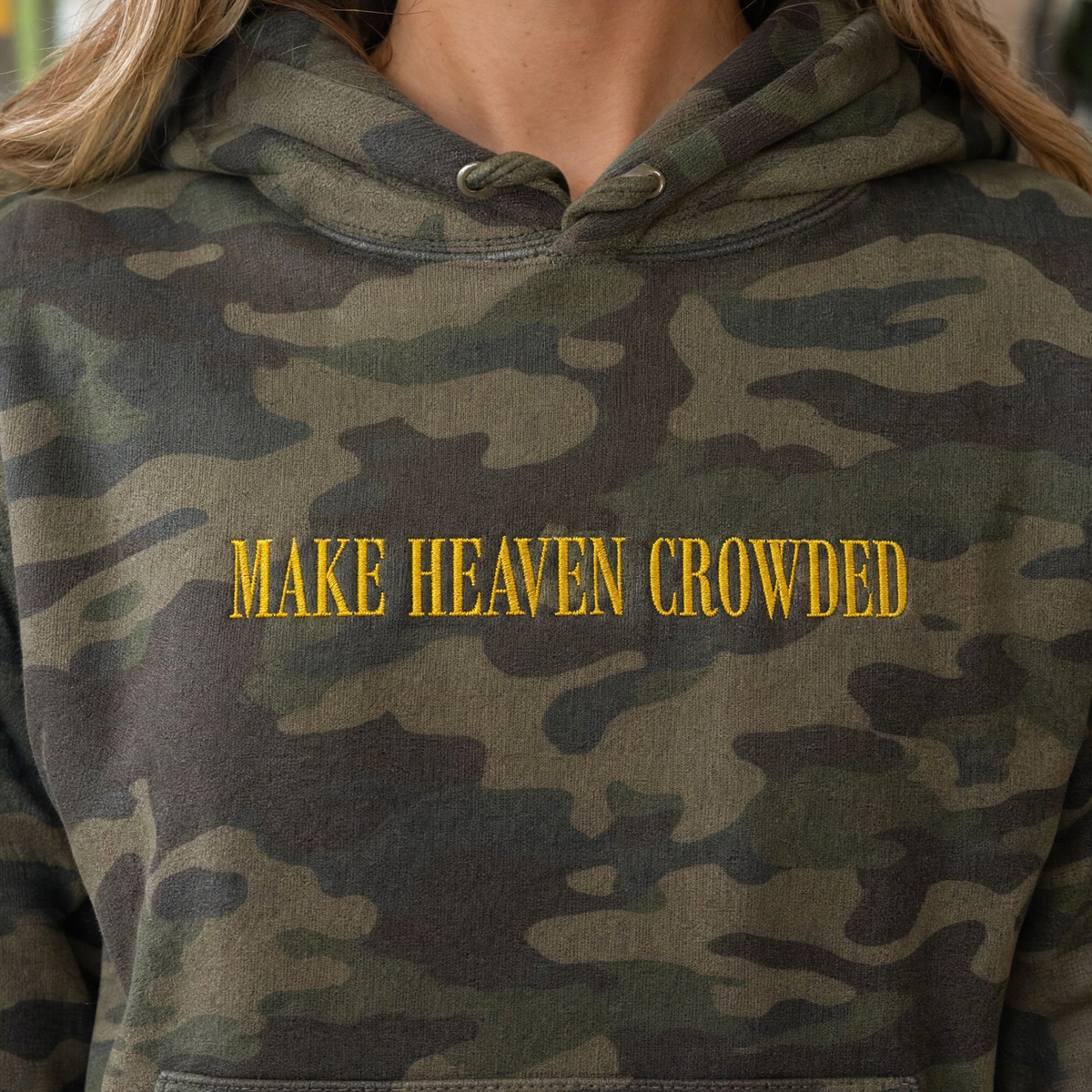 Model wearing the Make Heaven Crowded heavyweight hoodie in Green Camo, lifestyle image 2