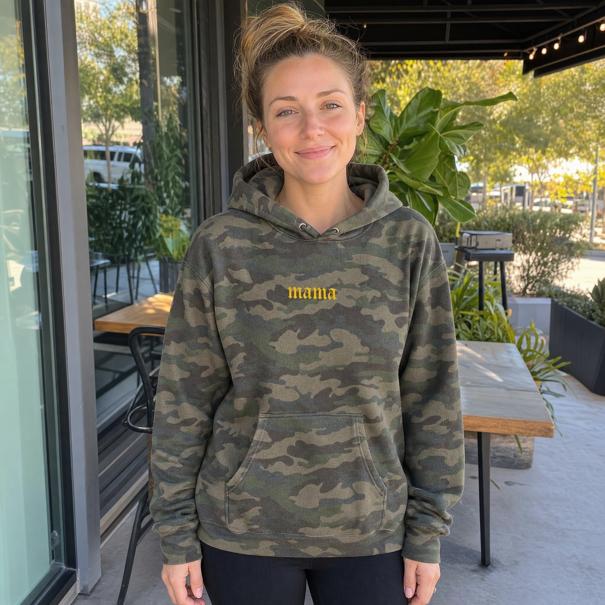 Model wearing the Mama heavyweight hoodie in Forest Camo, lifestyle image 1