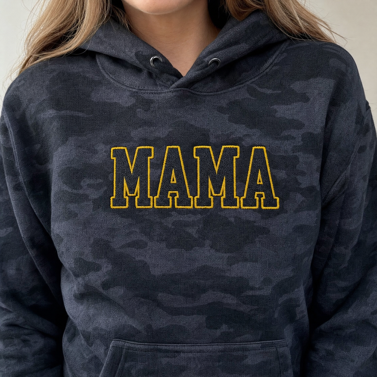 Model wearing the Mama Outline Text heavyweight hoodie in Black Camo, lifestyle image 2