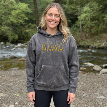 Model wearing the Mama Outline Text heavyweight hoodie in Dark Tree Camo, cover image 1