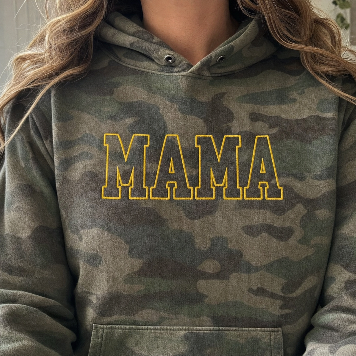 Model wearing the Mama Outline Text heavyweight hoodie in Green Camo, lifestyle image 2