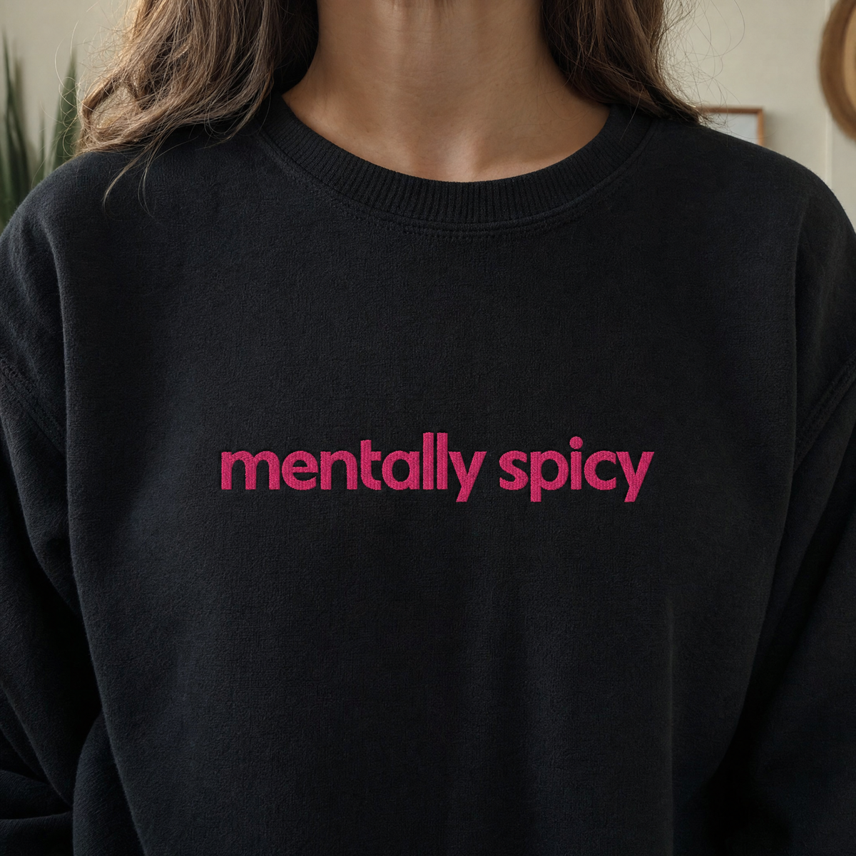 Model wearing the Mentally Spicy sweatshirt in Black, lifestyle image 1