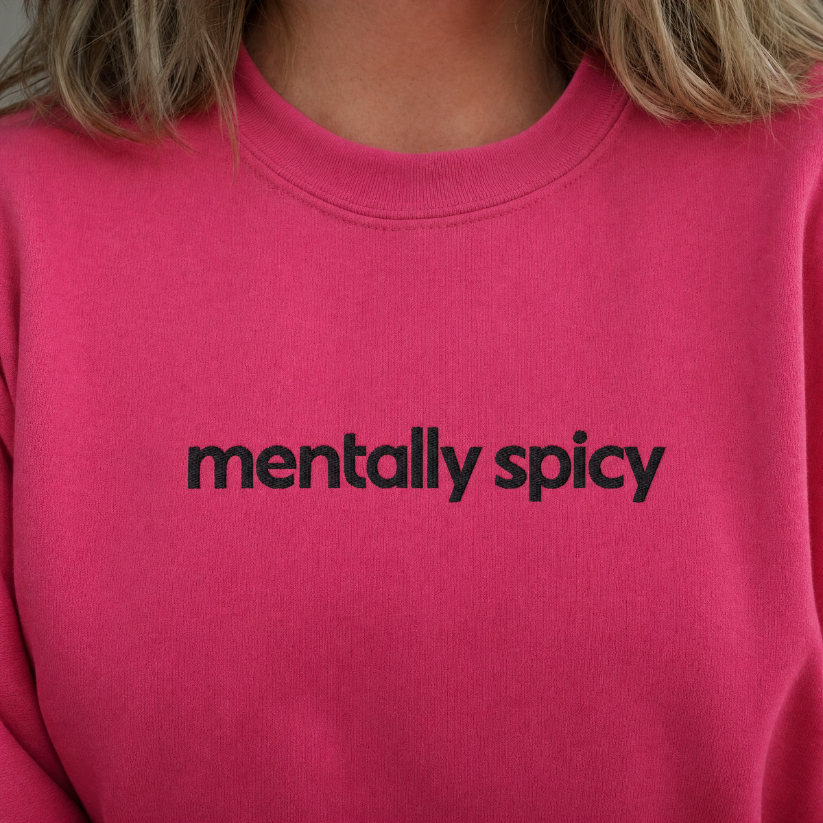 Model wearing the Mentally Spicy sweatshirt in Heliconia, lifestyle image 2