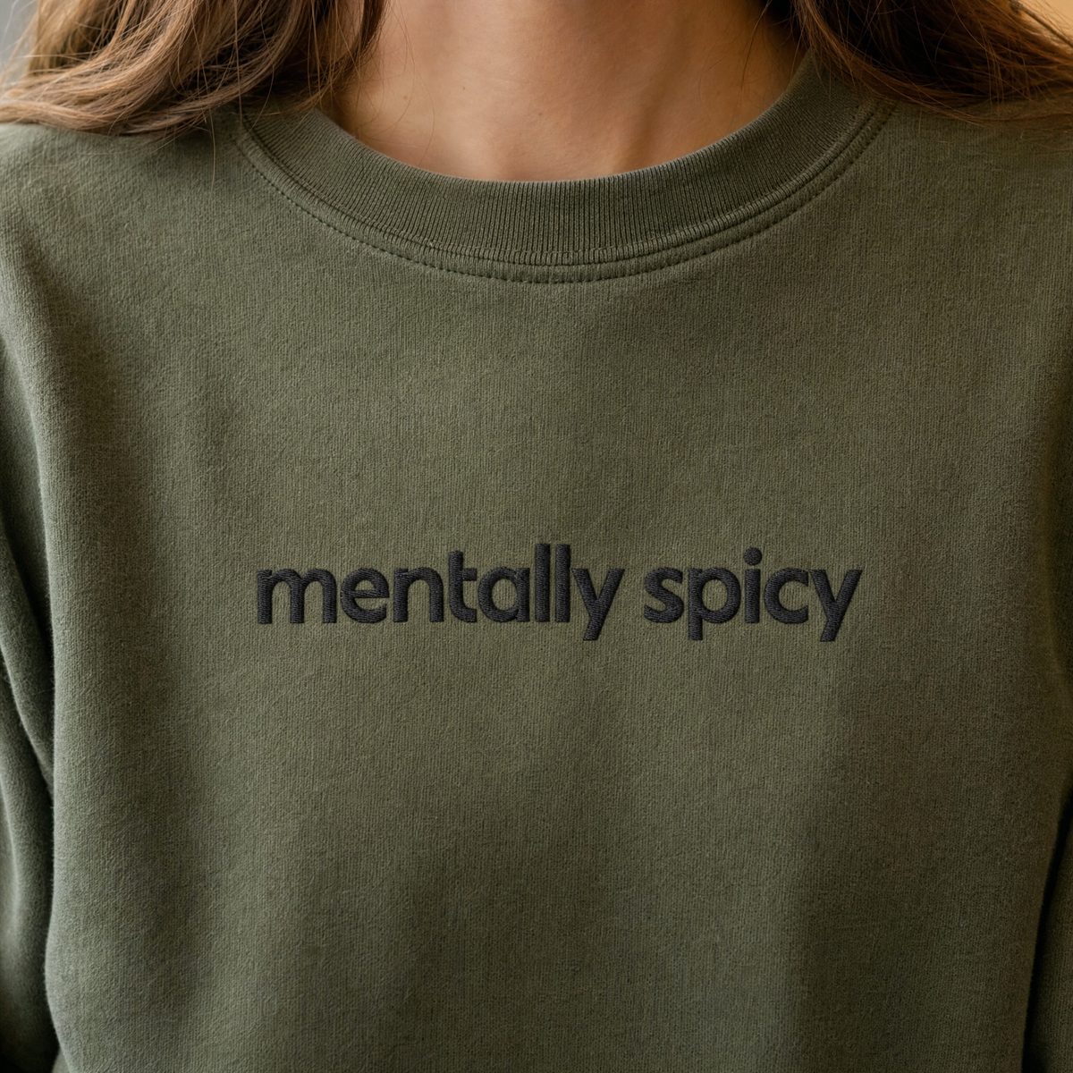 Model wearing the Mentally Spicy sweatshirt in Military Green, lifestyle image 2